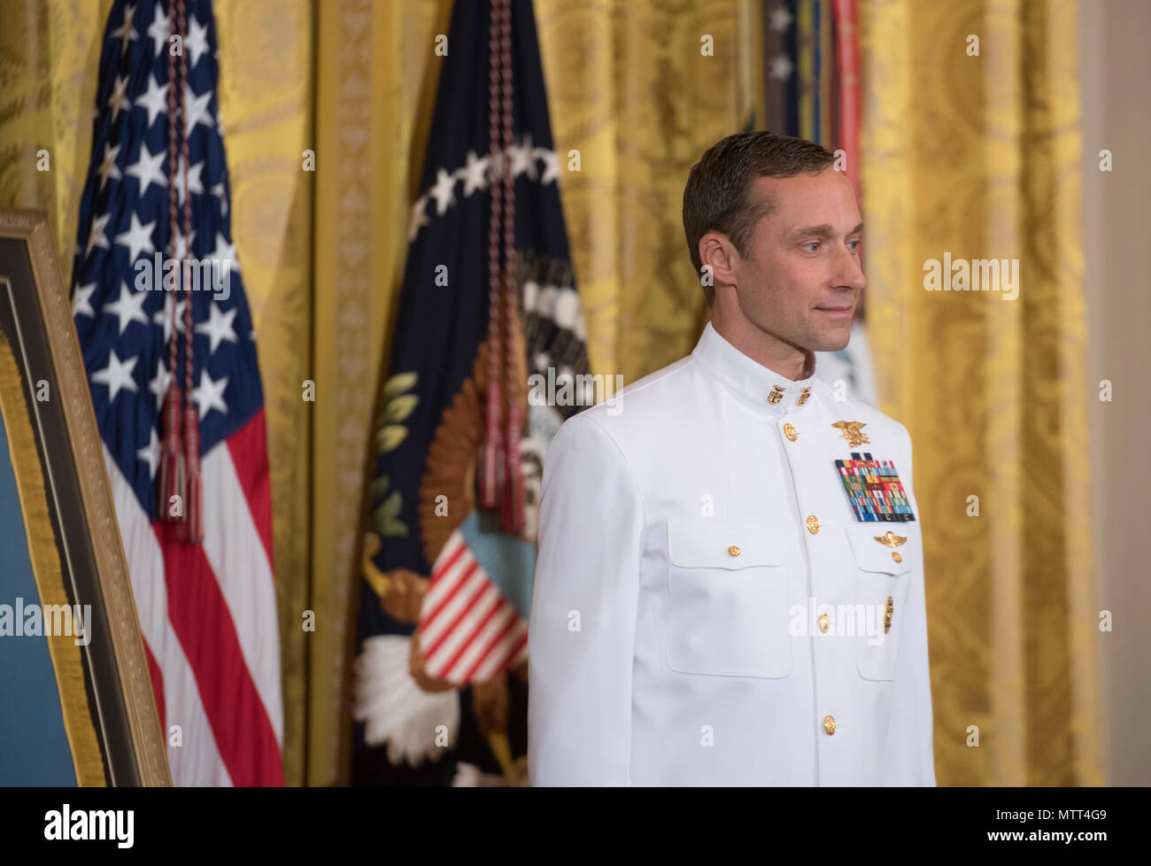 180524-N-BB269-006  WASHINGTON (May 24, 2018) Retired Master Chief Special Warfare Operator (SEAL) Britt Slabinski stands at attention during a Medal of Honor ceremony at the White House in Washington, D.C. Slabinski received the Medal of Honor for his actions during Operation Anaconda in Afghanistan in March 2002. (U.S. Navy photo by Mass Communication Specialist 1st Class Raymond D. Diaz III/Released) Stock Photo
