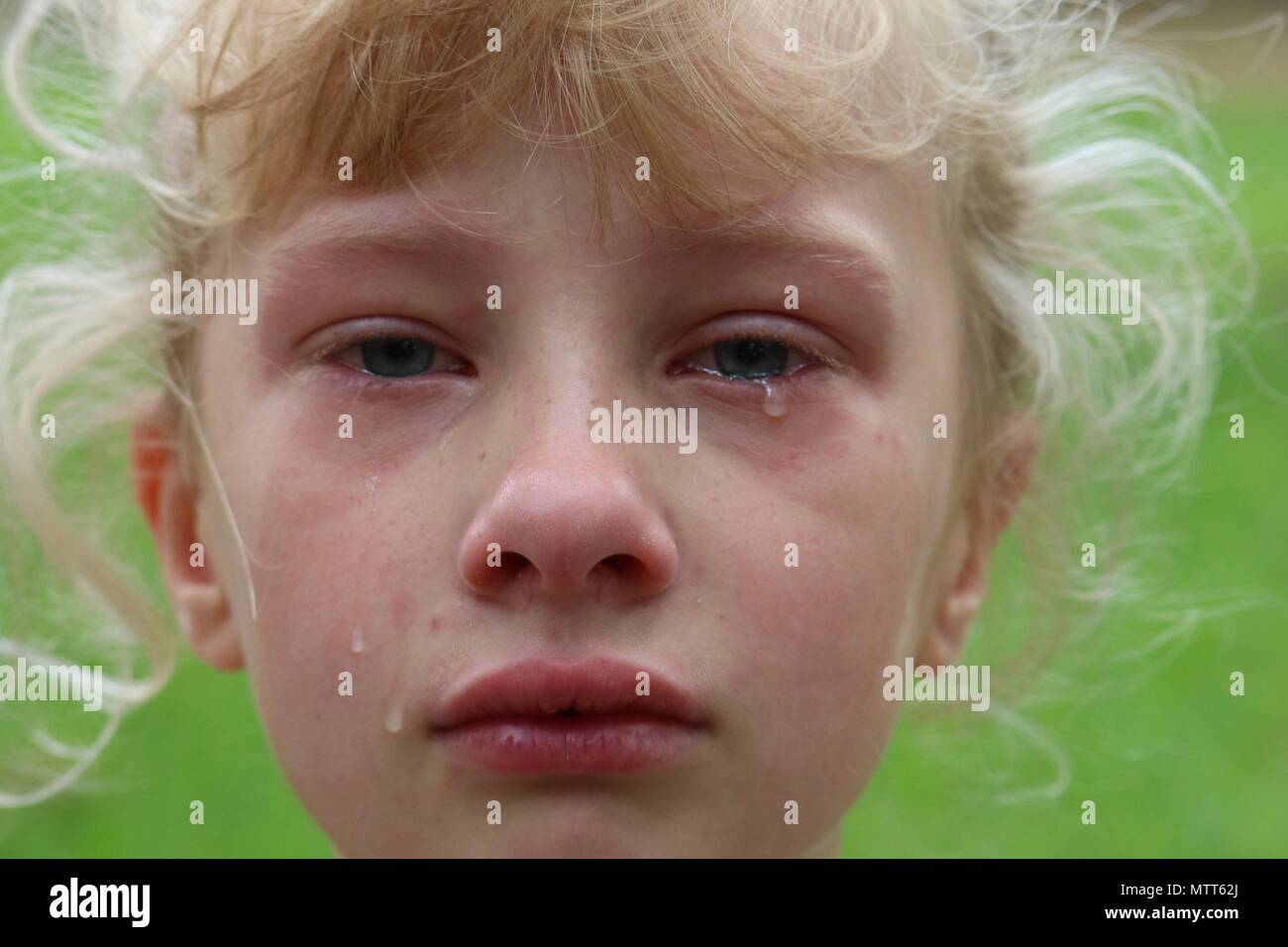 Closeup of a young girl with tears rolling down her cheek Stock Photo