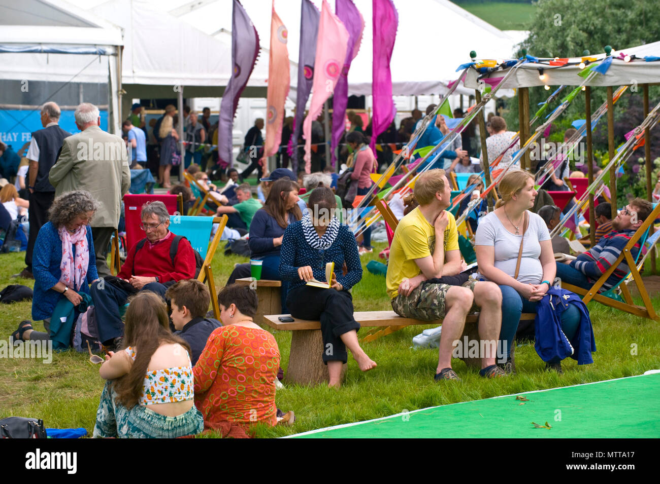 Visitors relax outside in the garden area at Hay Festival 2018 Hay-on-Wye Powys Wales UK Stock Photo