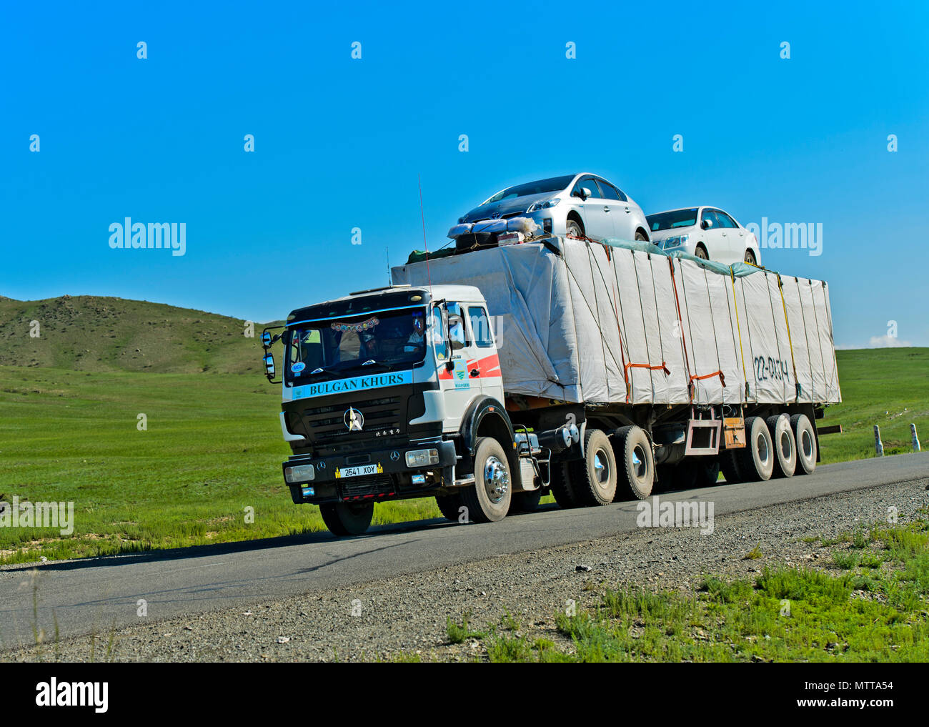 Risky transport of two cars on a truck, Mongolia Stock Photo