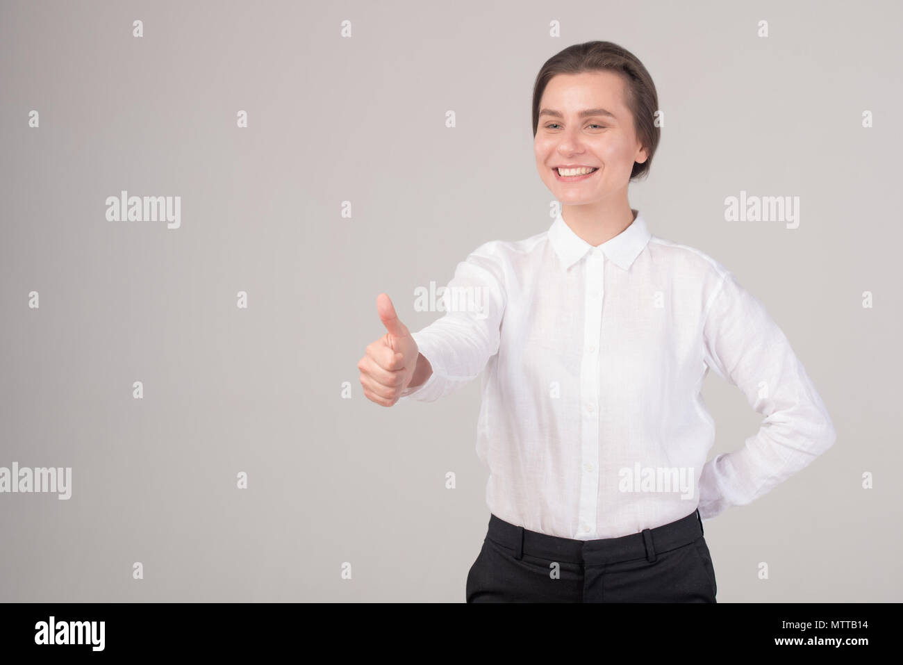 Thumb Up . Young Woman Show Bottle Of Water . Isolated Studio Portrait Of  Female Model . Stock Photo, Picture and Royalty Free Image. Image 84081688.