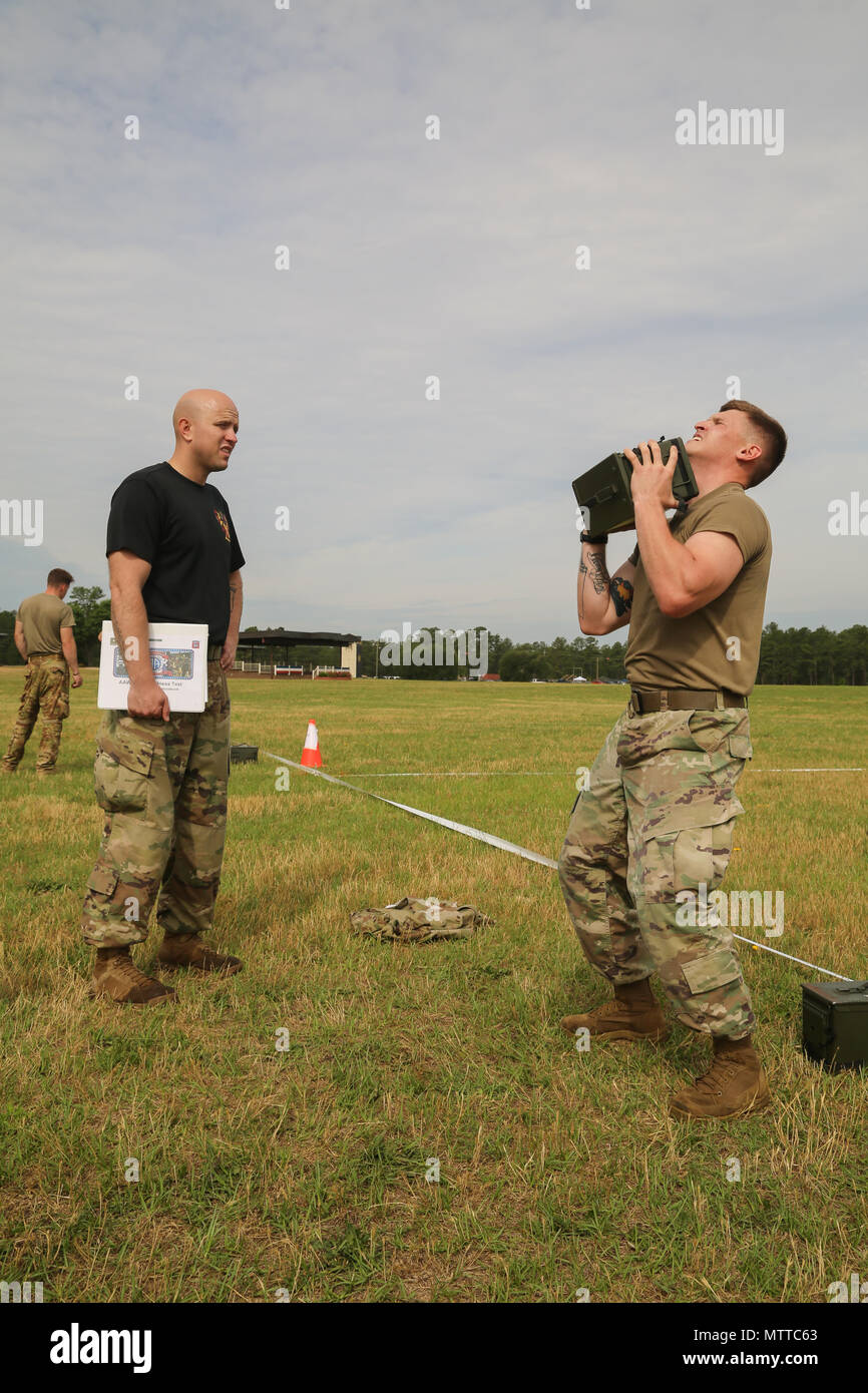 U.S. Army Sgt. John Saylor, assigned to 189th CSSB 249 CSC, 82nd Airborne Division, performs the Ammunition Lift portion of the All American Week XXIX Combat Fitnees Test on Pike Field at Fort Bragg, N.C., May 21, 2018.During All American Week XXIX, paratroopers from all over the 82nd Division compete in a series of events, The Combat Fitness Test is an event designed to test a Paratrooper's functional fitness and gives a more accurate representation of what Paratroopers are trained to do. (U.S. Army photo by Pfc. Tescia Mims) Stock Photo