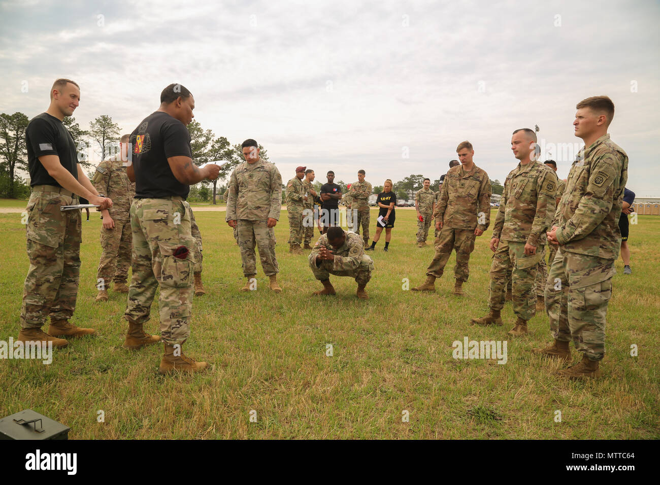 U.S. Army Paratroopers recieve a briefing before starting the Combat Fitness Test on Pike Field at Fort Bragg, N.C., May 21, 2018. During All American Week XXIX, paratroopers from all over the 82nd Division compete in a series of events, The Combat Fitness Test is an event designed to test a Paratrooper's functional fitness and gives a more accurate representation of what Paratroopers are trained to do. (U.S. Army photo by Pfc. Tescia Mims) Stock Photo