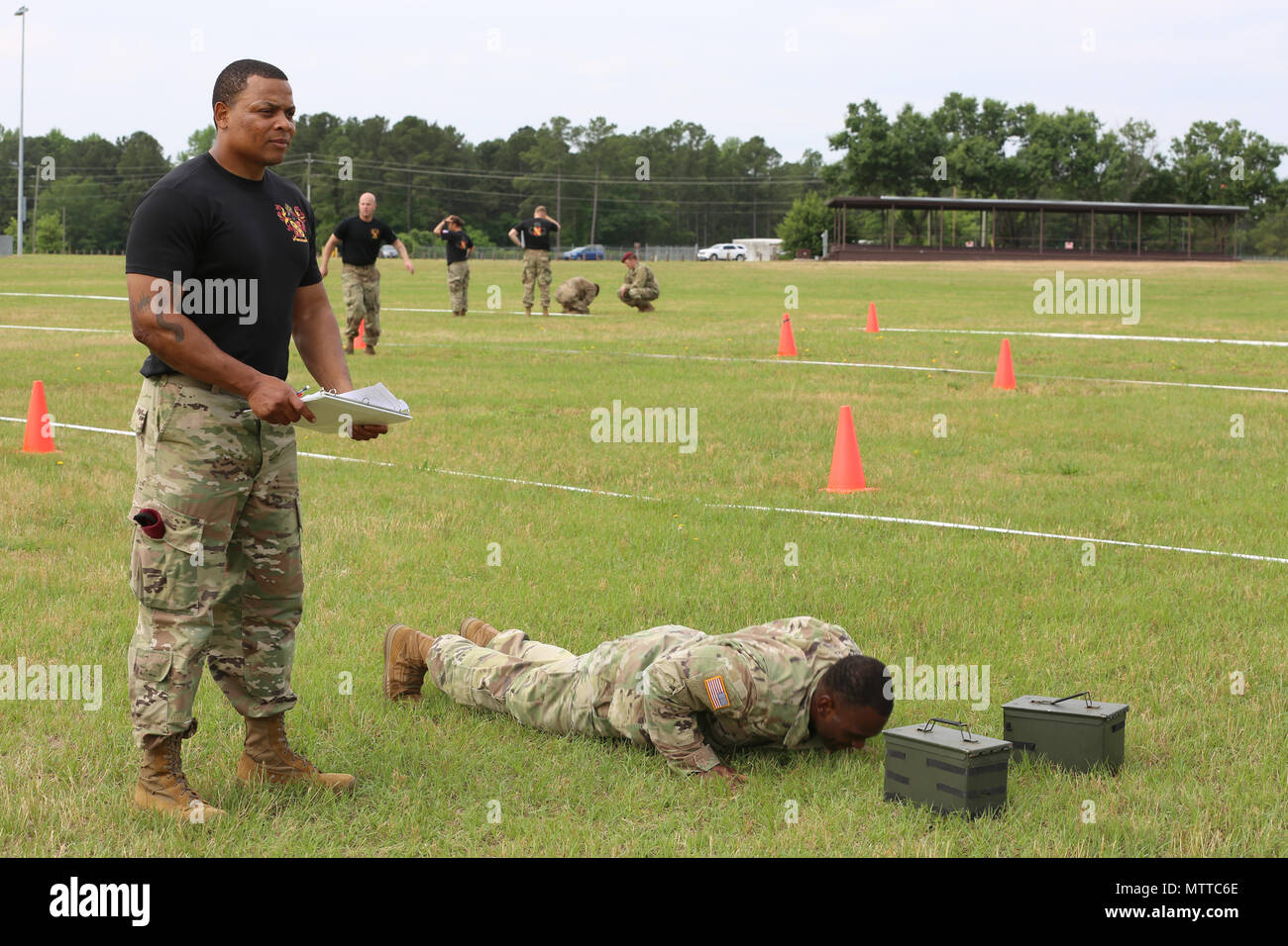 U.S. Army Sgt. Javonte Parker, assigned to 189th CSSB, Sustainment Brigade, 82nd Airborne Division, does pushups after throwing a grenade during the Maneuver Under Fire portion of the All American Week XXIX Combat Fitnees Test on Pike Field at Fort Bragg, N.C., May 21, 2018.During All American Week XXIX, paratroopers from all over the 82nd Division compete in a series of events, The Combat Fitness Test is an event designed to test a Paratrooper's functional fitness and gives a more accurate representation of what Paratroopers are trained to do. (U.S. Army photo by Pfc. Tescia Mims) Stock Photo