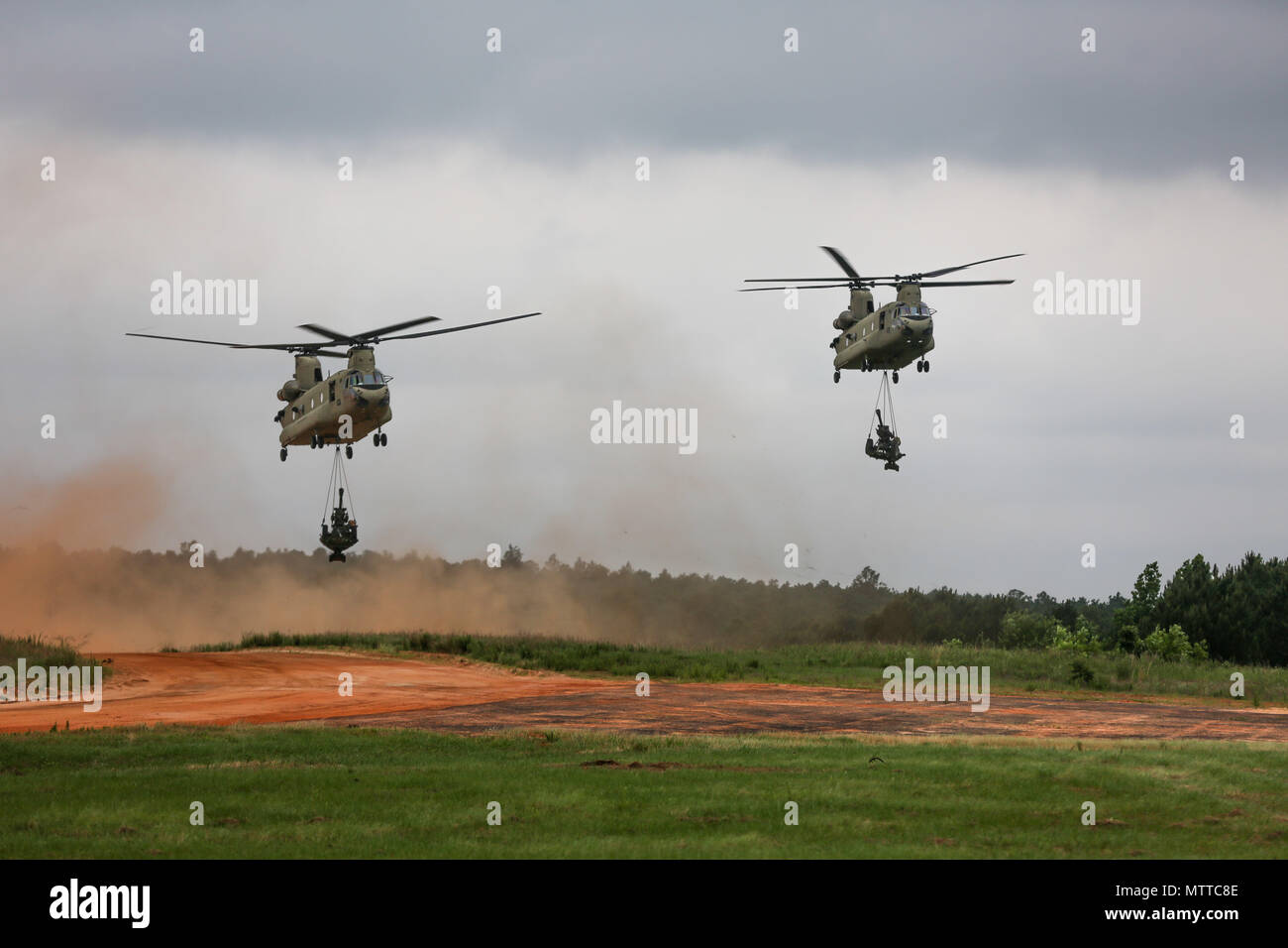 U.S. Army CH47 Chinooks drops M105 Howitzers at Sicily Drop Zone during the Airborne Review , All American Week XXIX May 24, 2018 at Fort Bragg, North Carolina . Paratroopers past and present converged on the center of the military universe to celebrate being members of the All American Division and America's Guard of Honor. (U.S Army photo by Spc. Jada Owens) Stock Photo