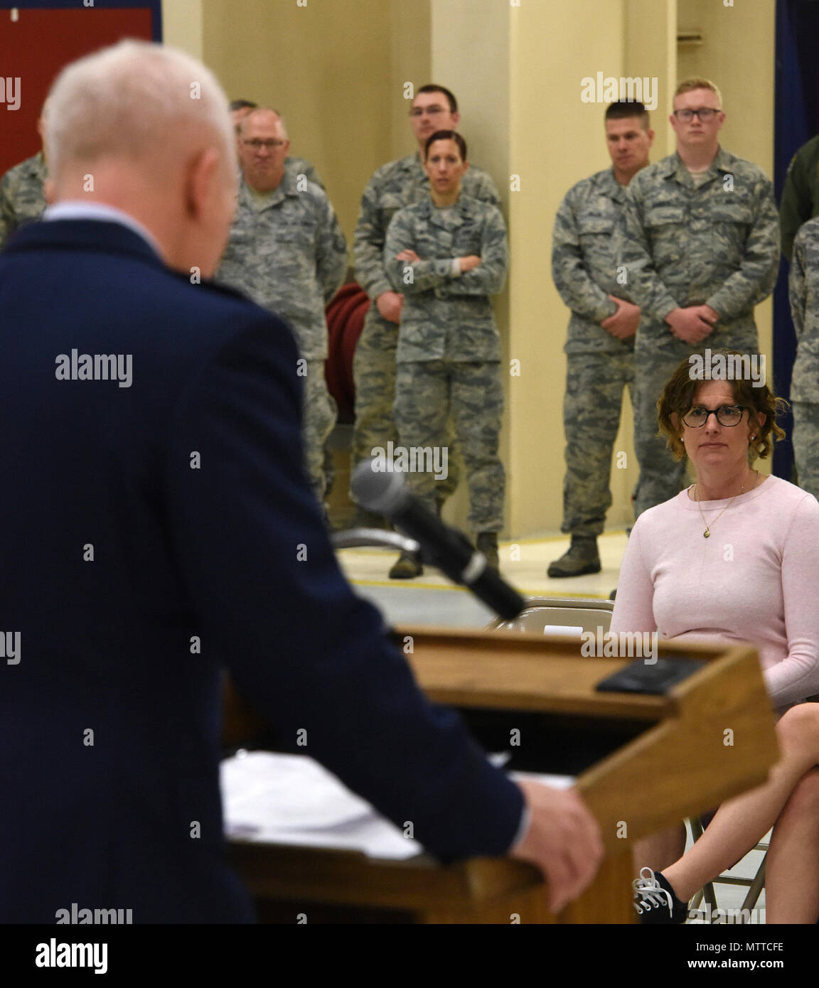 Mrs. Valerie Adams, wife of Col. Richard Adams, listens as her husband