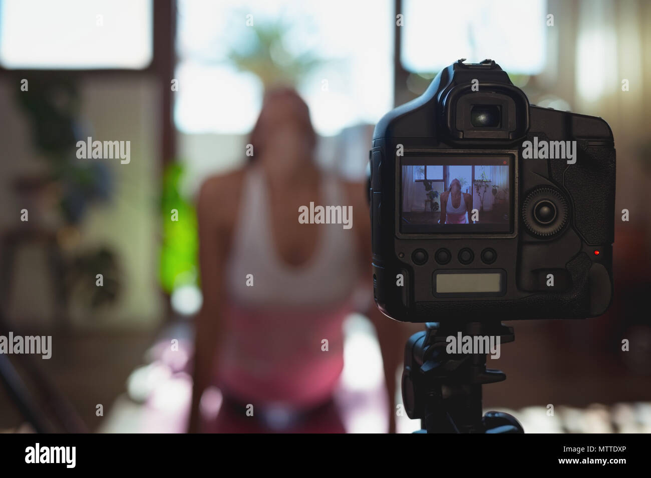 Female video blogger recording video vlog while exercising Stock Photo