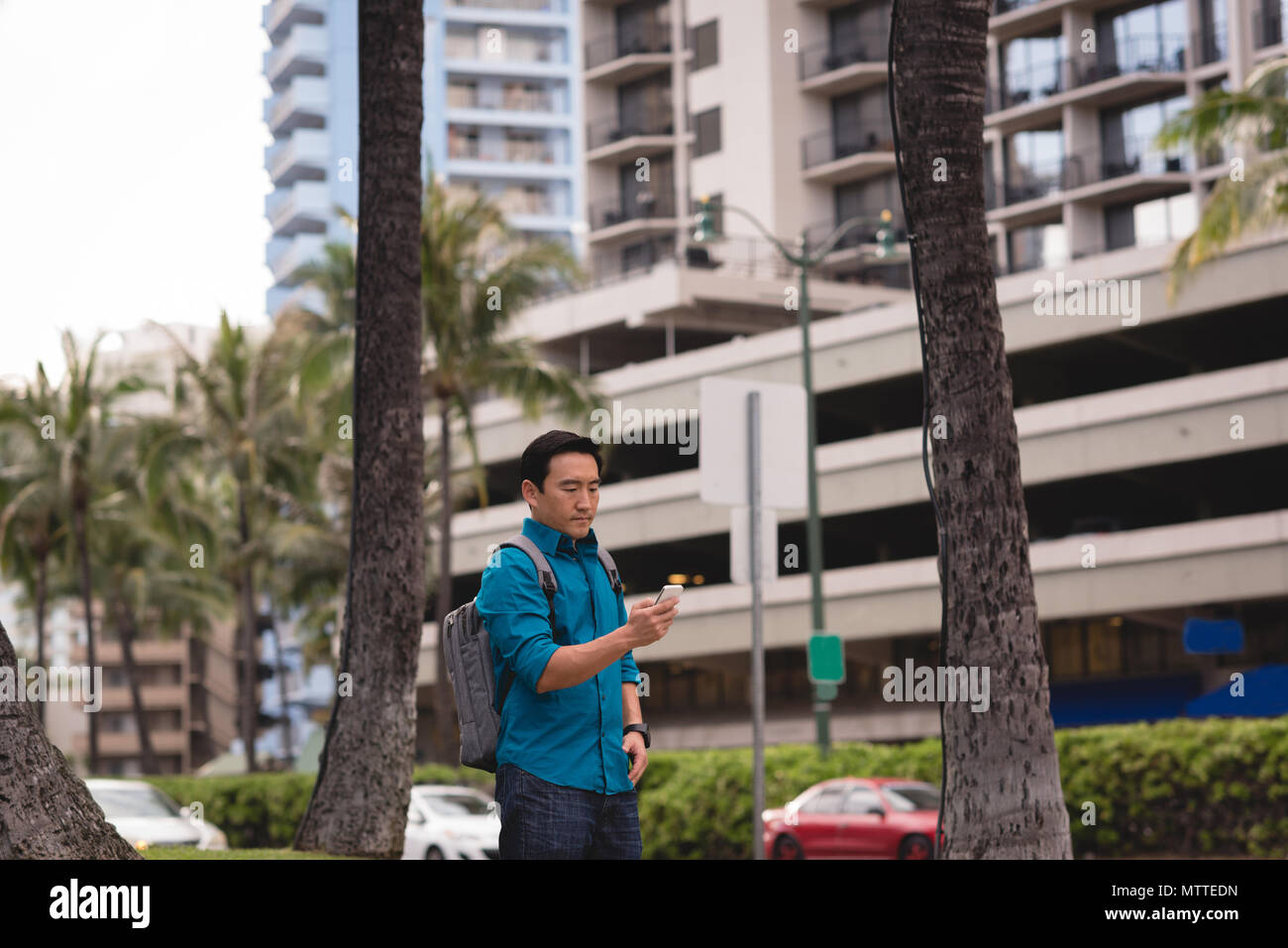 Man using mobile phone in city street Stock Photo