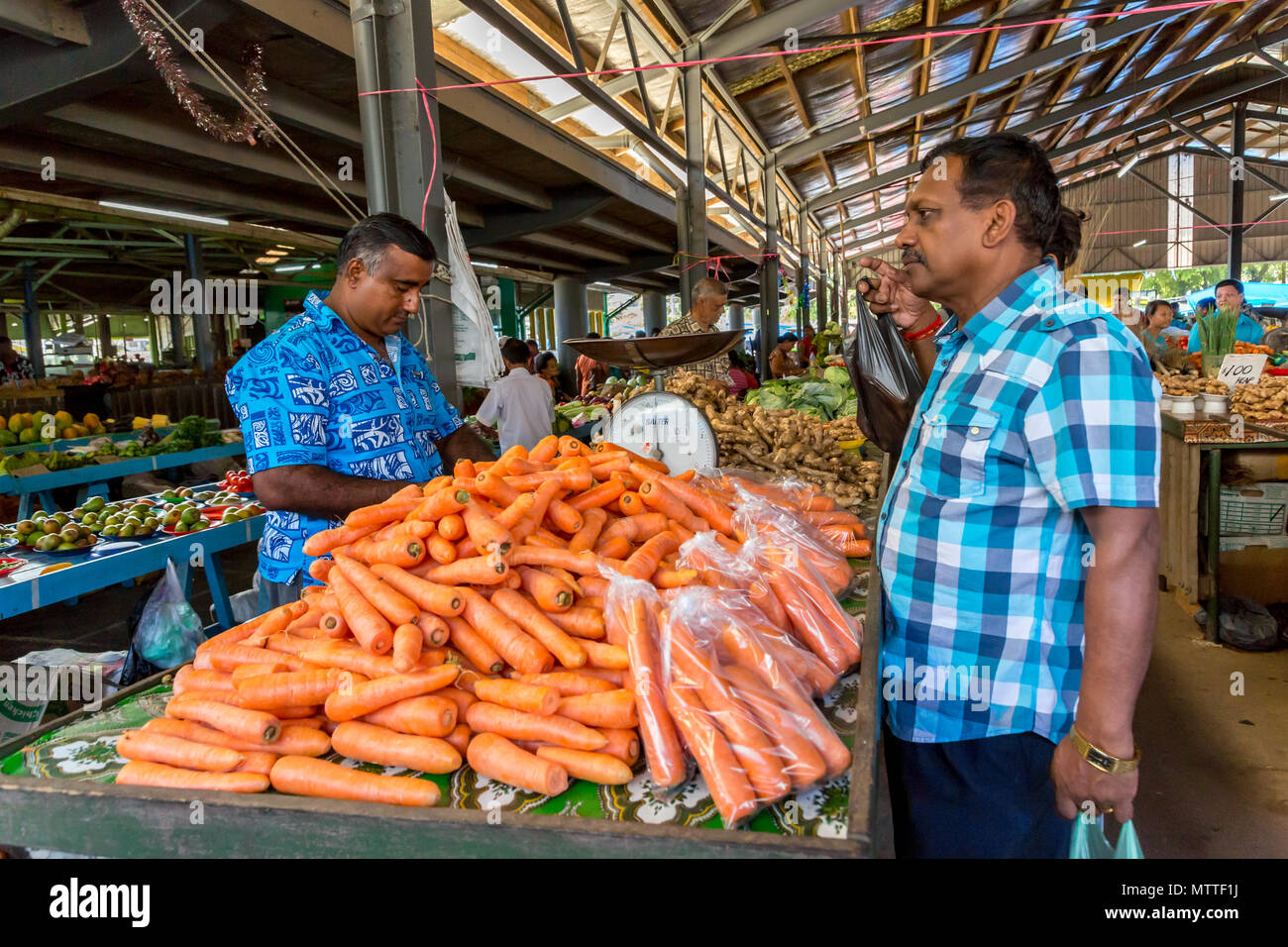 Carrot Merchant at local Fijian vegetable market in Nadi, Fiji Stock Photo