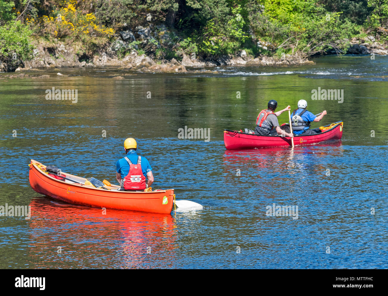RIVER SPEY SPEYSIDE SCOTLAND AT TAMDHU CANOE CANOEIST IN SPRING SUNSHINE TWO CANOES LOOKING DOWN THE RAPIDS Stock Photo