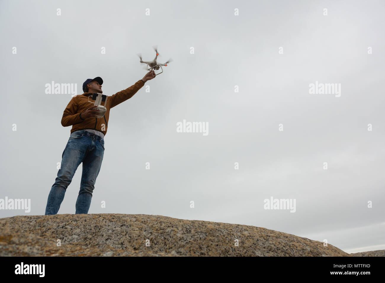 Man operating a flying drone Stock Photo
