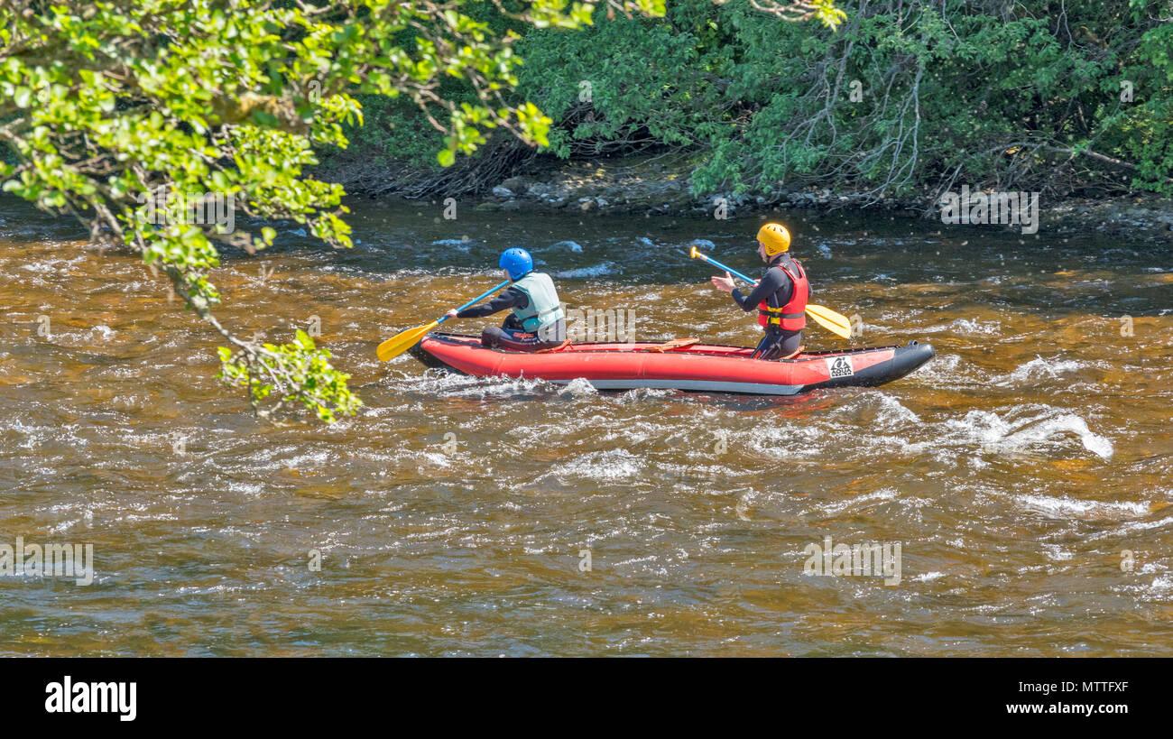 RIVER SPEY SPEYSIDE SCOTLAND CANOE CANOEIST SPRINGTIME ON THE SPEY AND A  RED AND BLUE INFLATABLE CANOE OR KAYAK AQUA DESIGN Stock Photo - Alamy