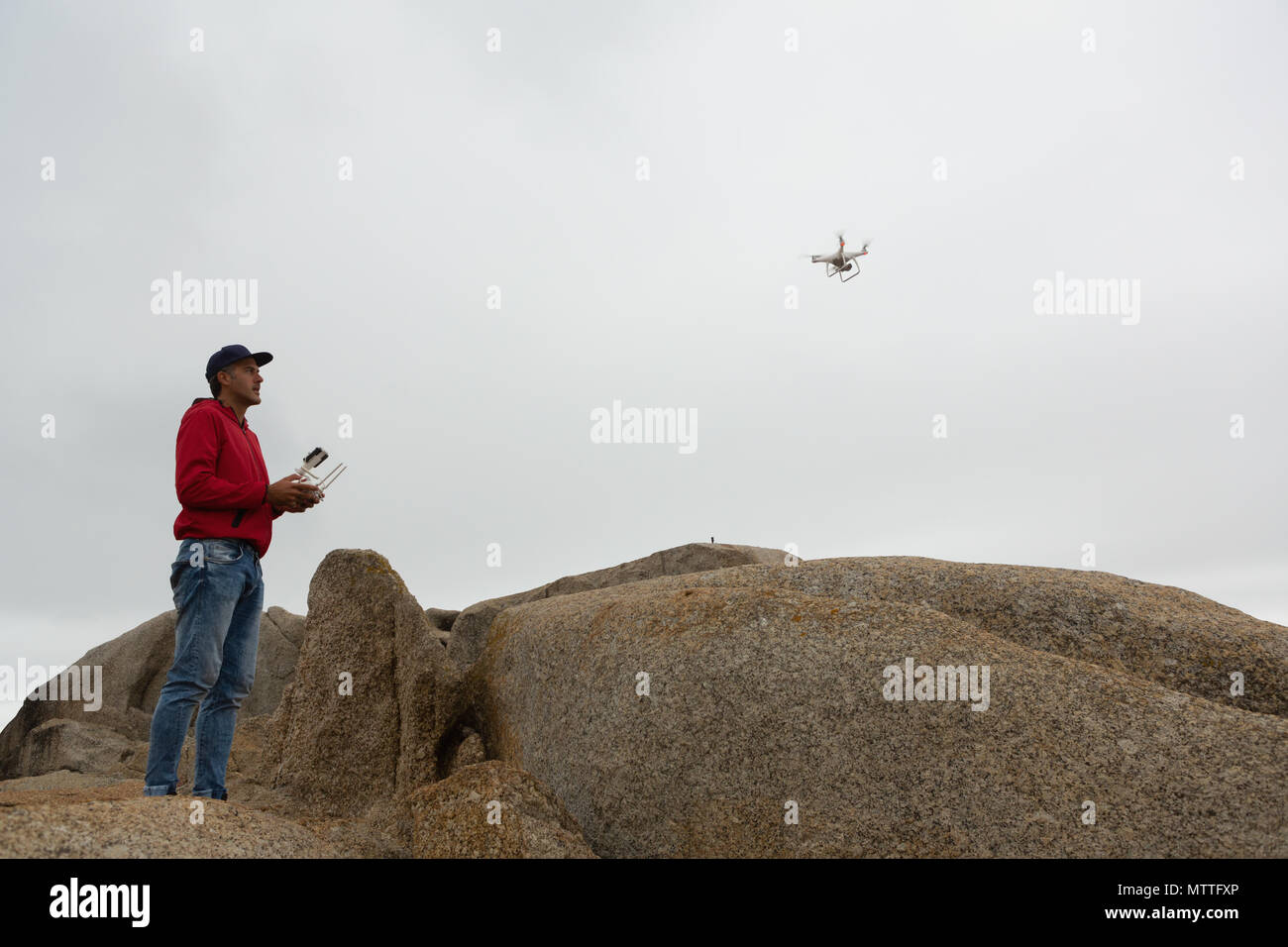 Man operating a flying drone Stock Photo