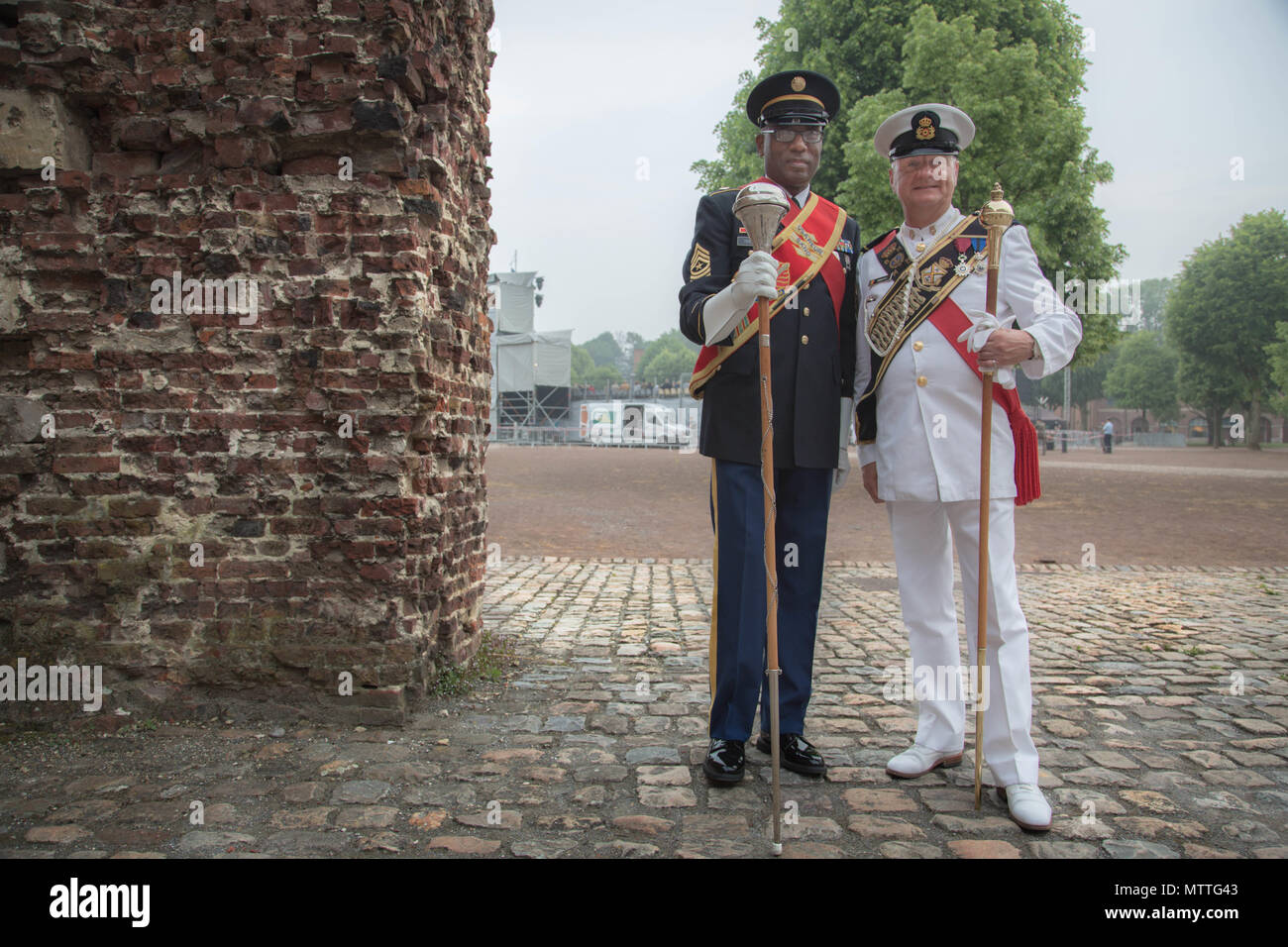 US drum major SGM Jesse L. Hughes Jr. stands alongside Major Hans Moreels of the German Heeresmusikorps during the Citadelle 350 anniversary military show, May 25, 2018, Lille, France.  US Army photo by SGT Joseph Agacinski/released. Stock Photo