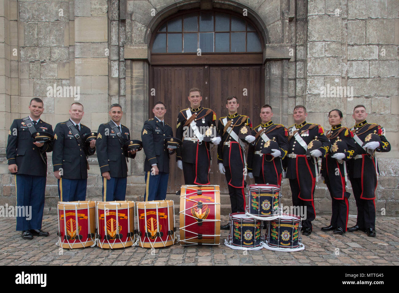 US Army Europe Band drummers stand alongside the drummers of the Royal Logistics Corps at the Citadelle 350 anniversary military show, May 25, 2018, Lille, France.  US Army photo by Sgt. Joseph Agacinski/released. Stock Photo