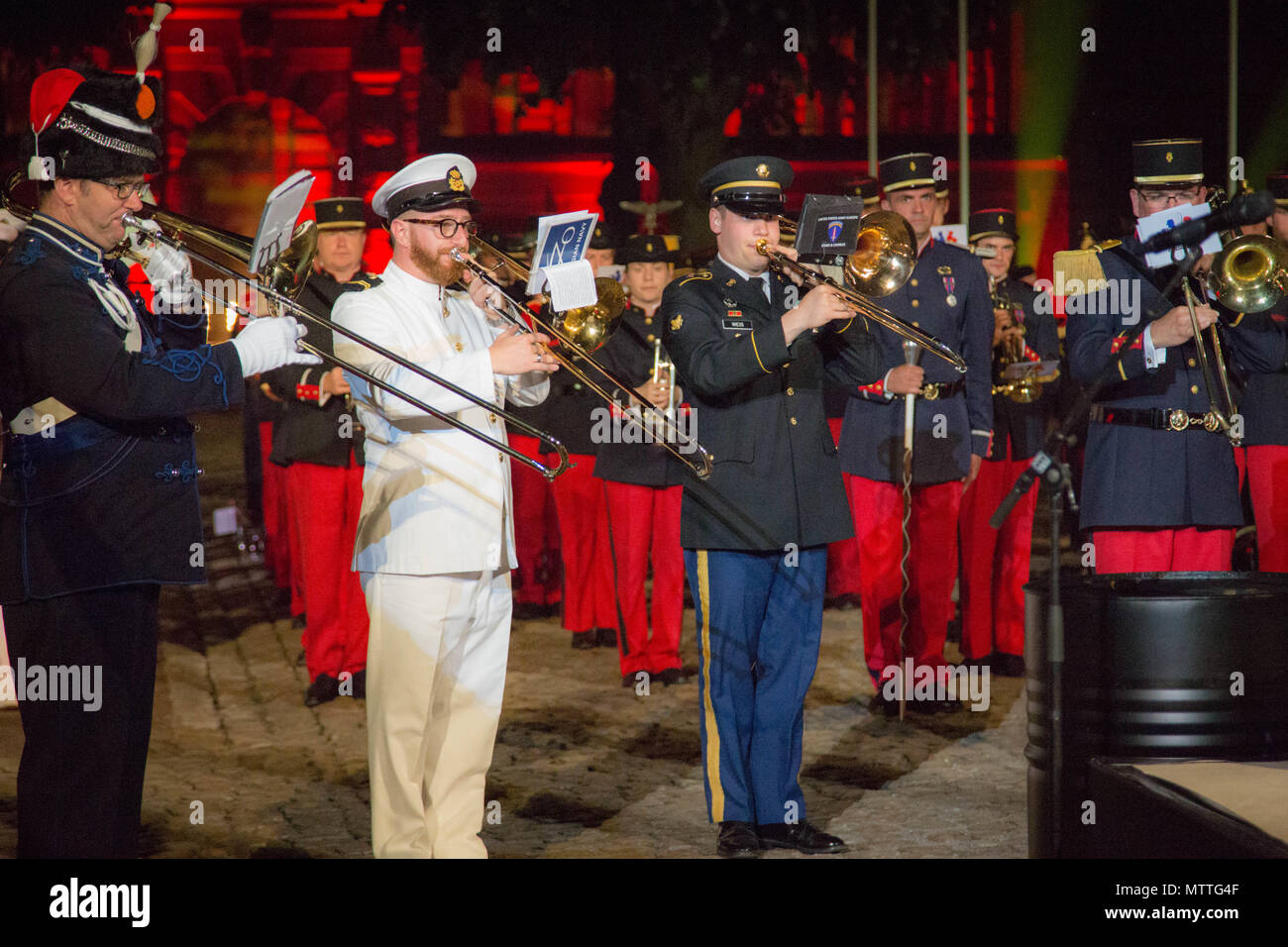 Spc Patrick Weiss, 3rd from the left, performs alongside the international trombone soloists for the Citadelle 350 anniversary military show, May 25, 2018, Lille, France.  US Army photo by Sgt Joseph Agacinski/released. Stock Photo