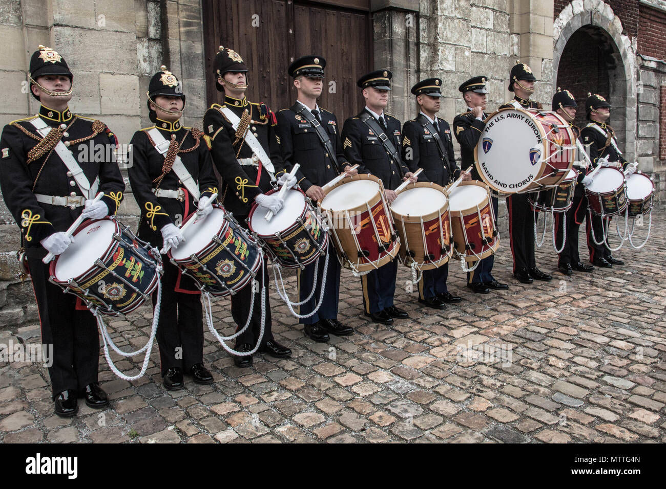 US Army Europe Band drummers stand alongside the drummers of the Royal Logistics Corps at the Citadelle 350 anniversary military show, May 25, 2018, Lille, France.  US Army photo by Sgt. Joseph Agacinski/released. Stock Photo