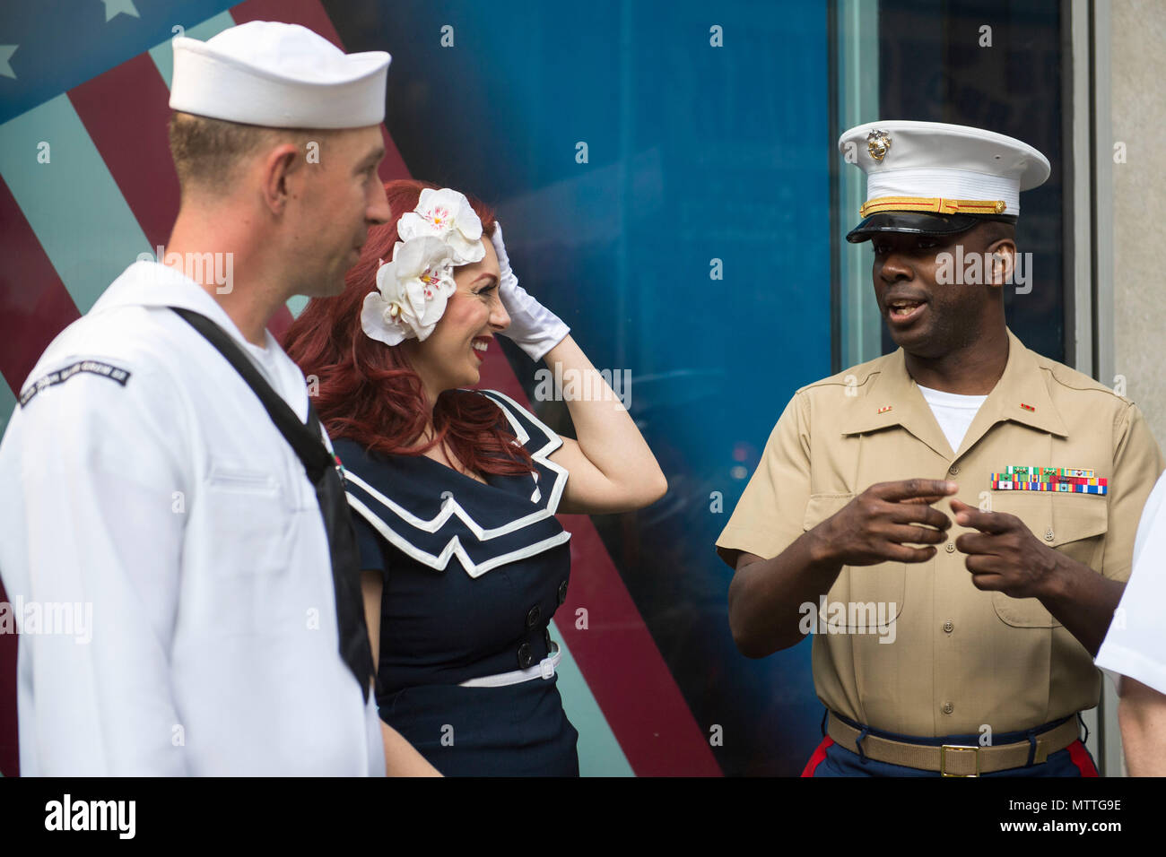 180526-N-HB733-0054 NEW YORK (May 25, 2018) Mineman 1st Class Keenan Rogers, of Minneapolis, Minnesota, assigned to the Littoral Combat Ship USS Little Rock (LCS 9), and Chief Warrant Officer Avin Hinton of Chesapeake City, Maryland, assigned to the Combat Logistics Regiment 25, speak with a member from the American Bombshells at the Fox and Friends Morning show BBQ competition during Fleet Week New York (FWNY). Now in its 30th year, FWNY is the city’s time-honored celebration of the sea services. It is an unparalleled opportunity for the citizens of New York and the surrounding tri-state area Stock Photo