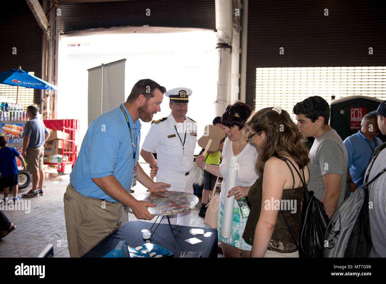 180526-N-IT235-0087 NEW YORK (May 26, 2018) Michael Jones, the environmental resources and planning section head for U.S. Fleet Forces Command’s Fleet Environmental and Readiness Division, explains the shipboard waste process to reduce plastic waste aboard ships at the U.S. Navy’s “Stewards of the Sea: Defending Freedom, Protecting the Environment” exhibit during Fleet Week New York. The Navy employs every means available to mitigate the potential environmental effects of our activities without jeopardizing the safety of our Sailors or impacting our Navy readiness mission. (U.S. Navy photo by  Stock Photo