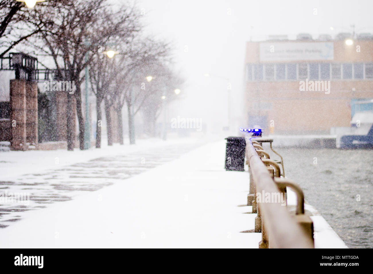 Snow falling on the esplanade of Hudson River Park in New York City