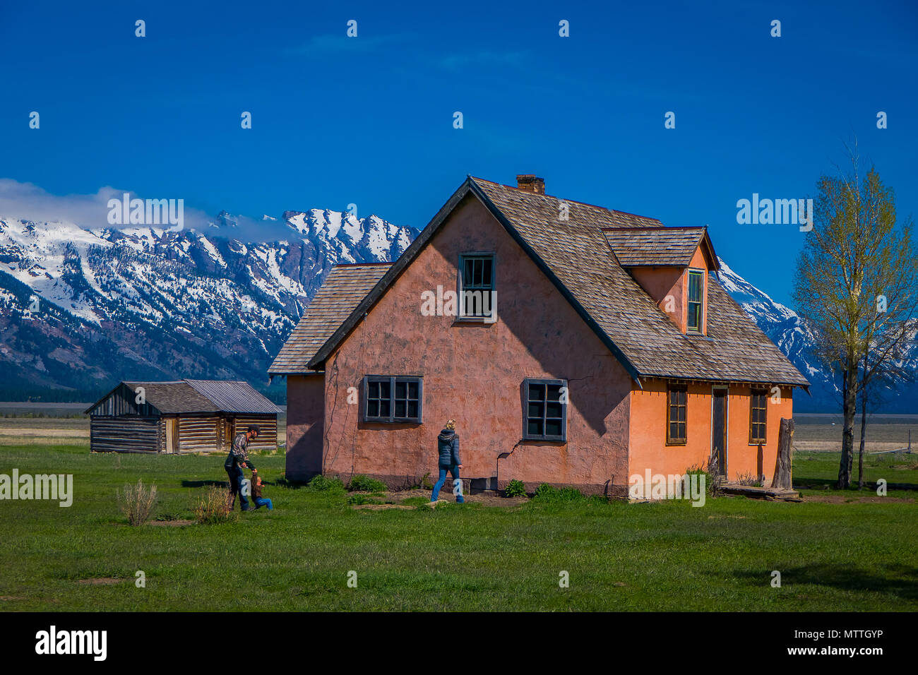 People walking at the enter of the Pink House on the John Moulton
