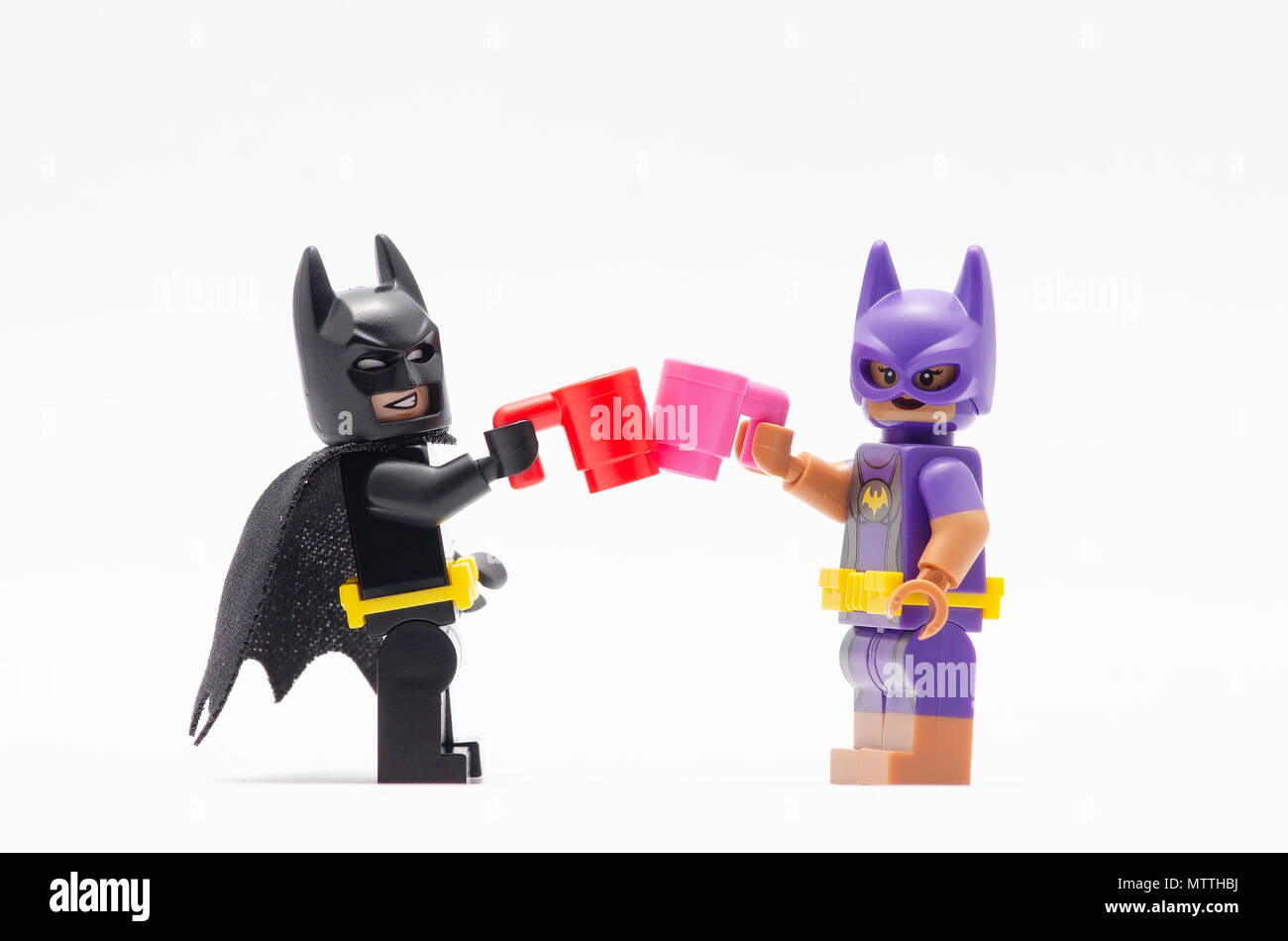 mini figure of batman and batgirl having a drink together. Lego minifigures  are manufactured by The Lego Group Stock Photo - Alamy