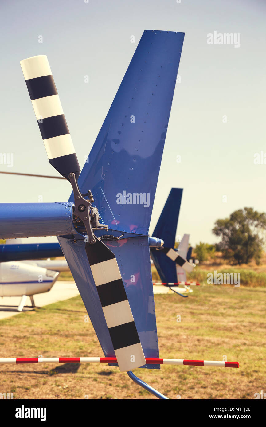 Row of tail rotors of Robinson helicopters during World Helicopter Day, operated by Balkan Helicopters. Vintage style. Stock Photo