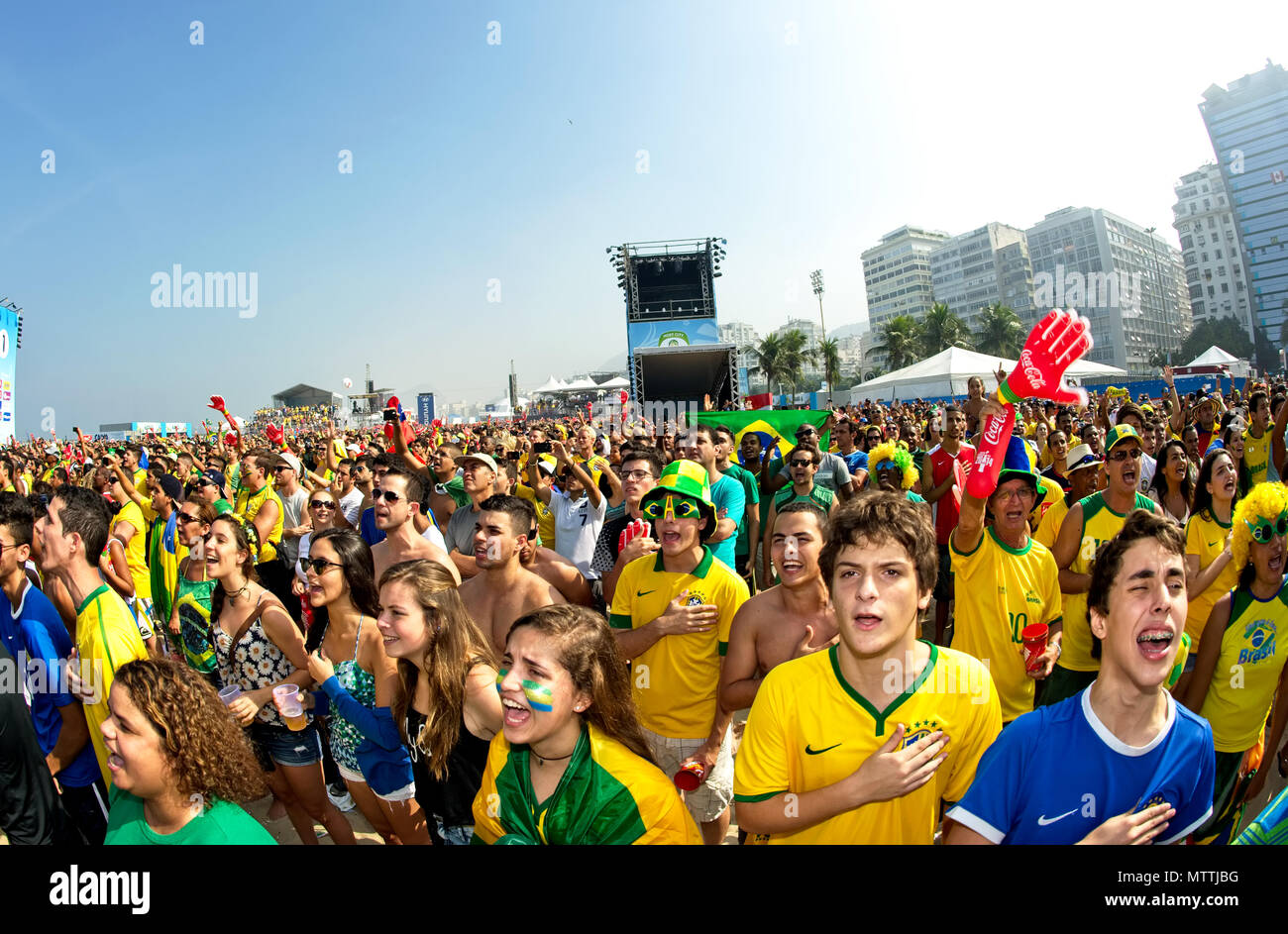 World Cup, Rio de Janeiro, Brazil - June 28, 2014: Soccer fans sing the Brazilian national anthem at the Fifa Fan Fest area on Copacabana beach Stock Photo