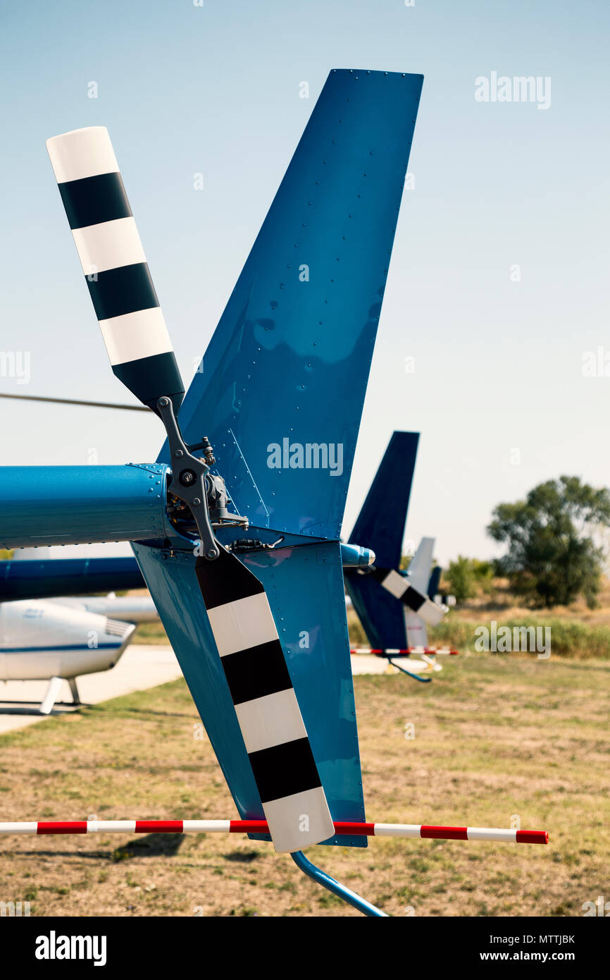 Row of tail rotors of Robinson helicopters during World Helicopter Day, operated by Balkan Helicopters.  Vintage style. Stock Photo