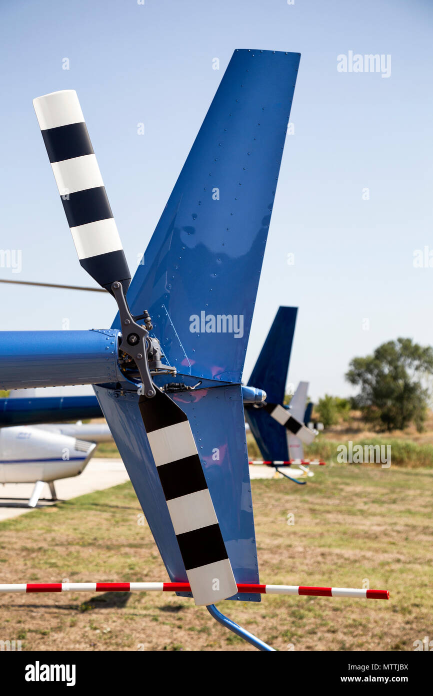 Row of tail rotors of Robinson helicopters during World Helicopter Day, operated by Balkan Helicopters. Stock Photo