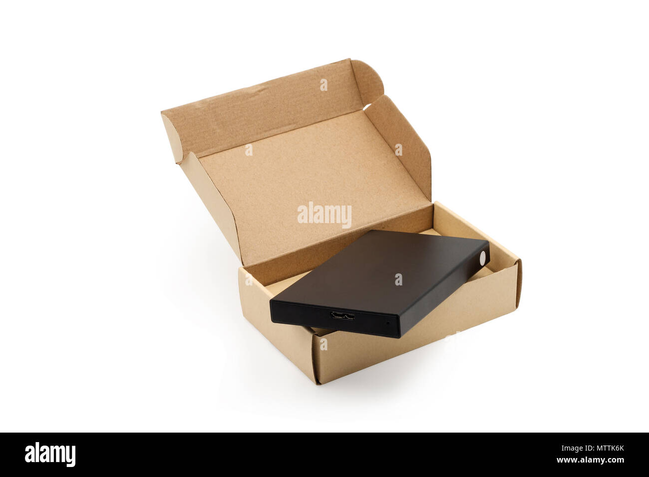 External hard drive of the computer in a cardboard box. Isolated on