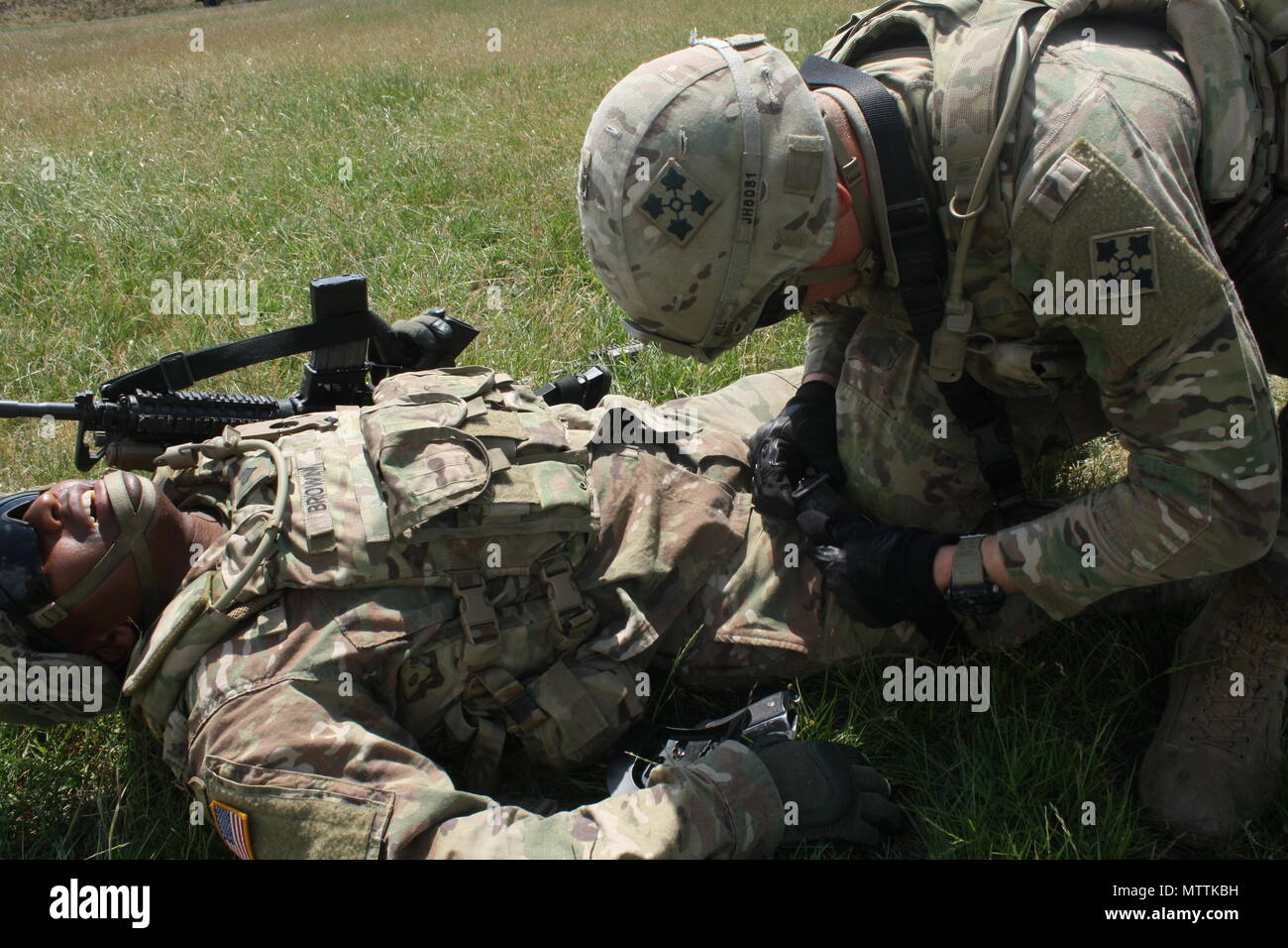 A Soldier simulates caring for a casualty during Advanced Rifle Marksmanship and Individual Movement Techniques training May 24 at Camp Marechal De Lattre De Tassigny, Kosovo. Stock Photo