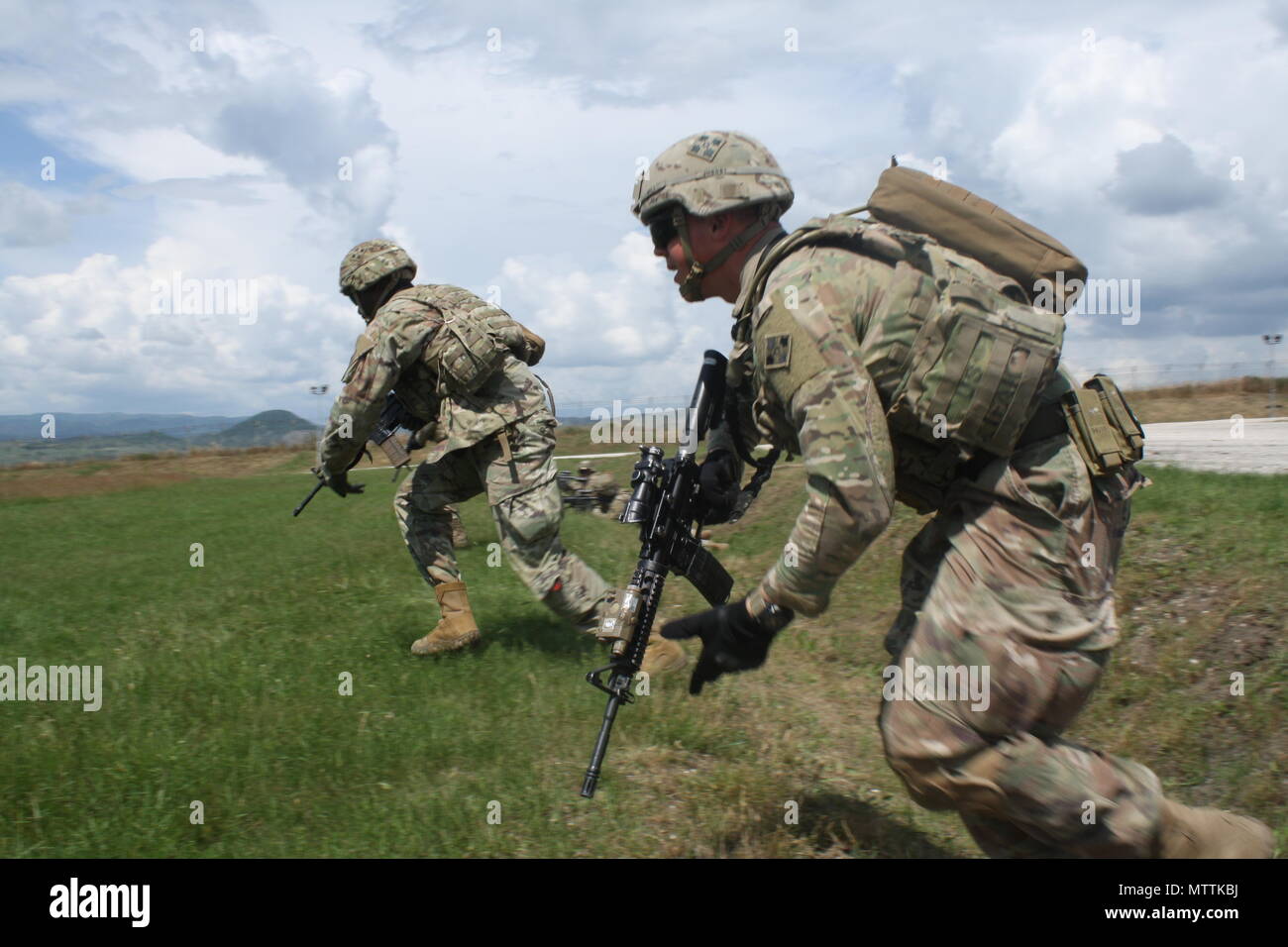 Soldiers bound forward toward the enemy during Advanced Rifle Marksmanship and Individual Movement Techniques training May 24 at Camp Marechal De Lattre De Tassigny, Kosovo. Stock Photo