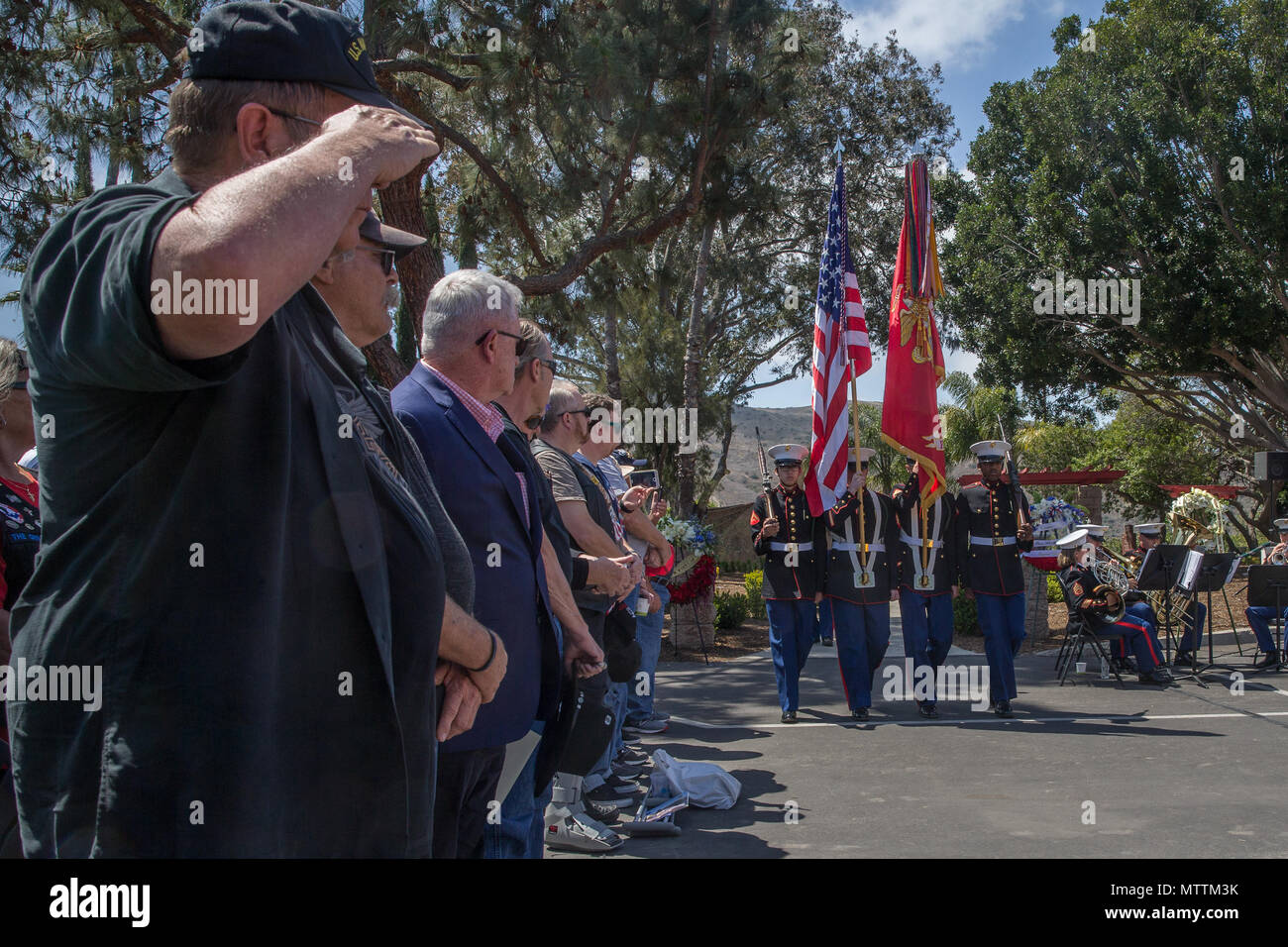 U.S. Marine Corps Veterans salute during the 5th Marines Vietnam War Memorial unveiling ceremony in the Camp San Mateo Memorial Garden at Marine Corps Base Camp Pendleton, Calif., May 28, 2018. The memorial is inscribed with the names of 2,706 Marines and sailors who gave their lives serving our great nation. (U.S. photo by Lance Cpl. Rhita Daniel) Stock Photo