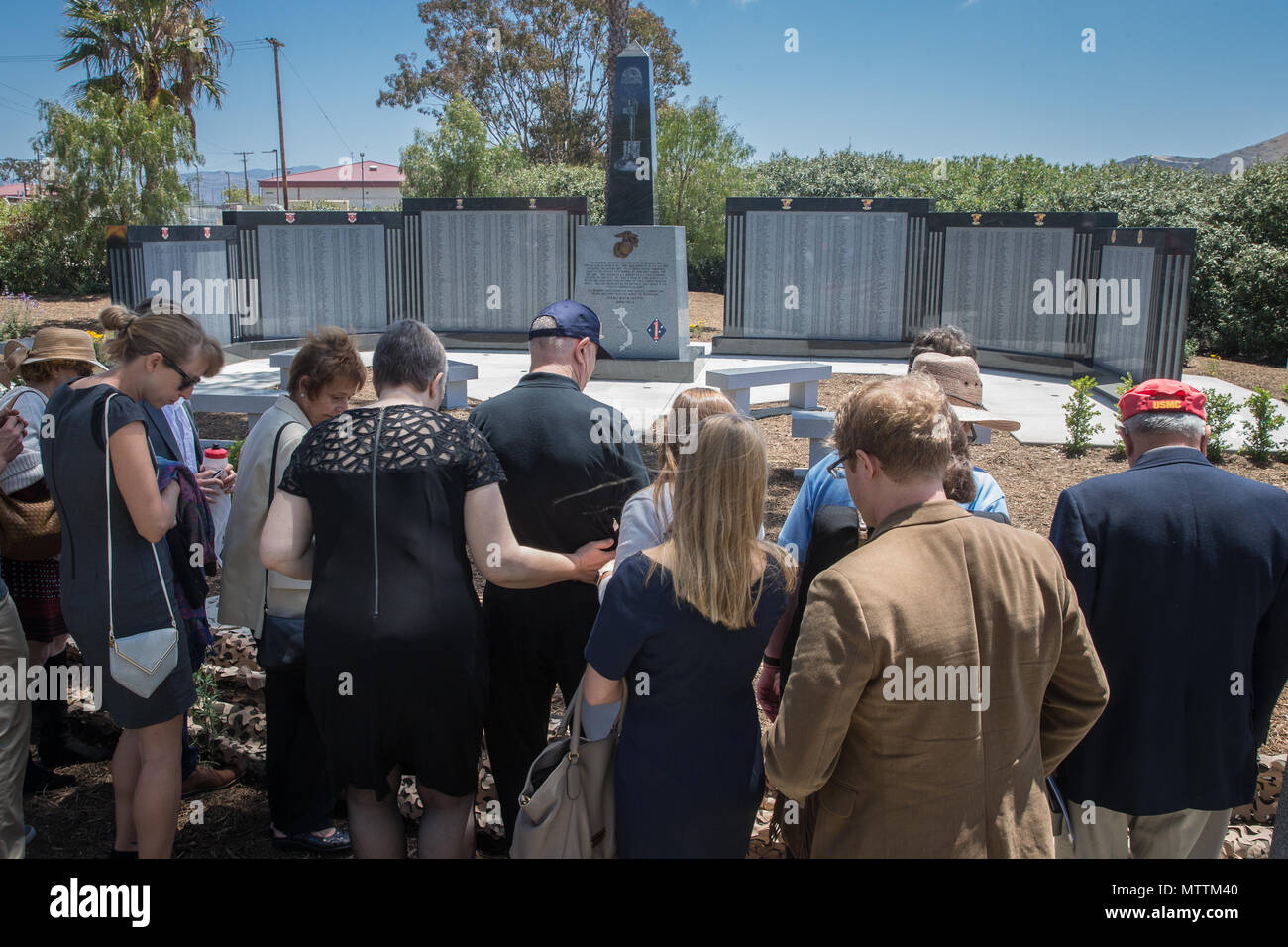 U.S. Marine Corps and Navy veterans observe the 5th Marines Vietnam War Memorial during the unveiling ceremony in the Camp San Mateo Memorial Garden at Marine Corps Base Camp Pendleton, Calif., May 28, 2018. The memorial is inscribed with the names of 2,706 Marines and sailors who gave their lives serving our great nation. (U.S. photo by Lance Cpl. Rhita Daniel) Stock Photo