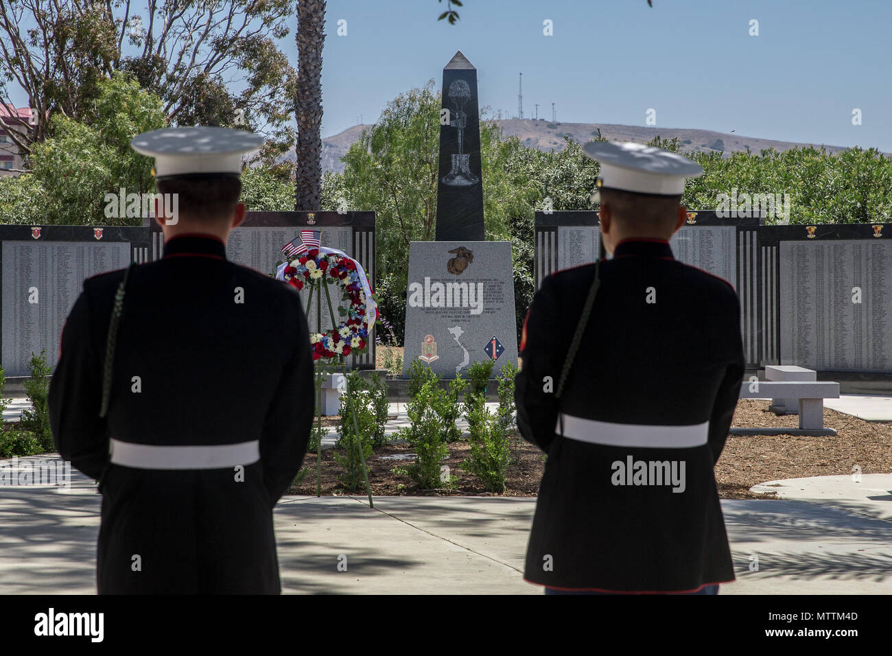 U.S. Marines with 5th Marine Regiment, 1st Marine Division, observe the 5th Marines Vietnam War Memorial unveiling ceremony in the Camp San Mateo Memorial Garden at Marine Corps Base Camp Pendleton, Calif., May 28, 2018. The memorial is inscribed with the names of 2,706 Marines and sailors who gave their lives serving our great nation. (U.S. photo by Lance Cpl. Rhita Daniel) Stock Photo
