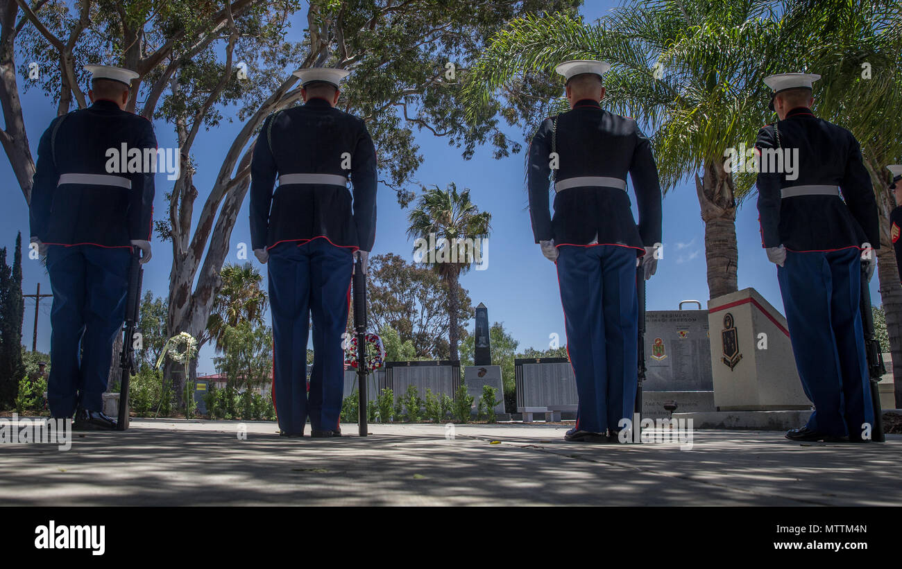 U.S. Marines with 5th Marine Regiment, 1st Marine Division, observe the 5th Marines Vietnam War Memorial during the unveiling ceremony in the Camp San Mateo Memorial Garden at Marine Corps Base Camp Pendleton, Calif., May 28, 2018. The memorial is inscribed with the names of 2,706 Marines and sailors who gave their lives serving our great nation. (U.S. photo by Lance Cpl. Rhita Daniel) Stock Photo