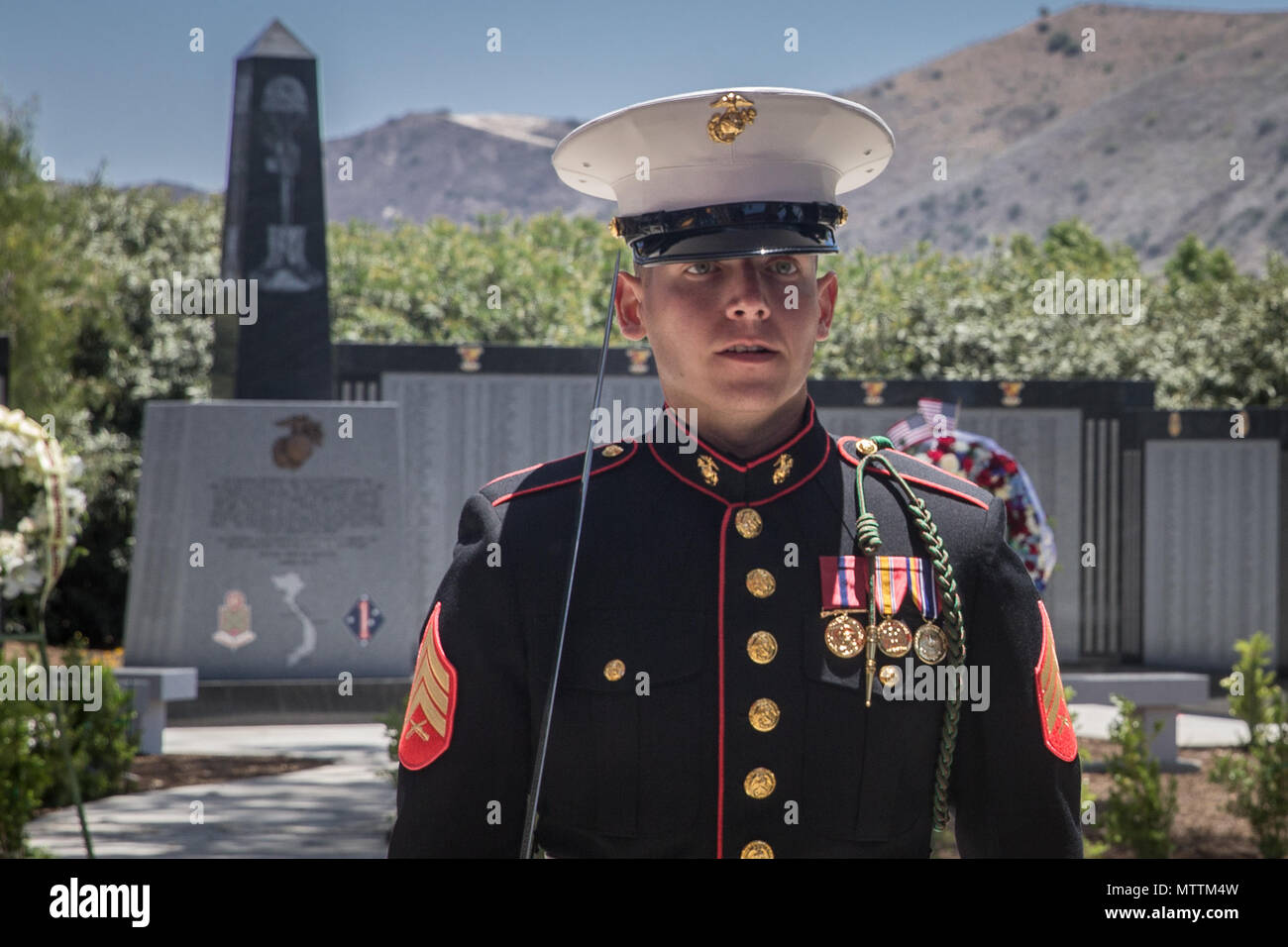 A U.S. Marine with 5th Marine Regiment, 1st Marine Division, marches by the 5th Marines Vietnam War Memorial during the unveiling ceremony in the Camp San Mateo Memorial Garden at Marine Corps Base Camp Pendleton, Calif., May 28, 2018. The memorial is inscribed with the names of 2,706 Marines and sailors who gave their lives serving our great nation. (U.S. photo by Lance Cpl. Rhita Daniel) Stock Photo
