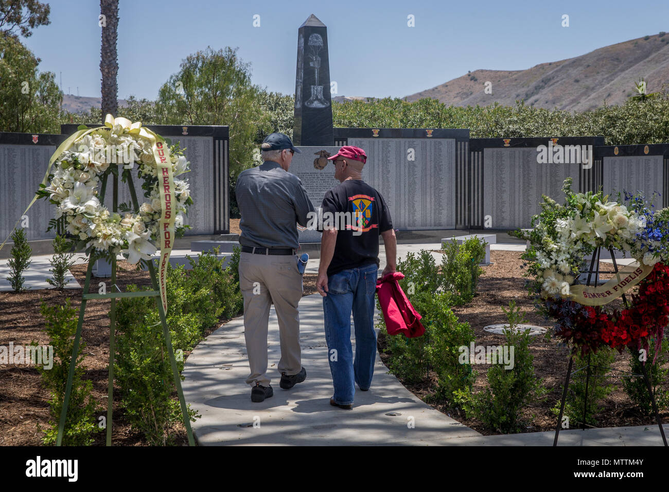 U.S. Marine Corps and Navy veterans observe the 5th Marines Vietnam War Memorial during the unveiling ceremony in the Camp San Mateo Memorial Garden at Marine Corps Base Camp Pendleton, Calif., May 28, 2018. The memorial is inscribed with the names of 2,706 Marines and sailors who gave their lives serving our great nation. (U.S. photo by Lance Cpl. Rhita Daniel) Stock Photo