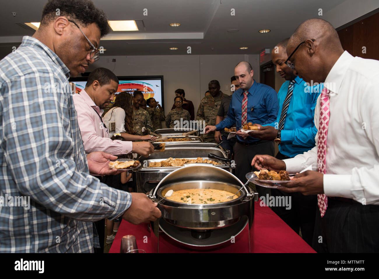 Team Shaw members fill their plates in a buffet line during an Asian