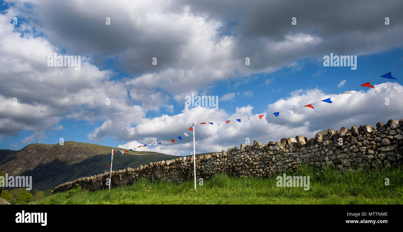 Summer bunting along a dry stone wall in Nether Wasdale, Lake District National Park, Cumbria, Uk. Stock Photo