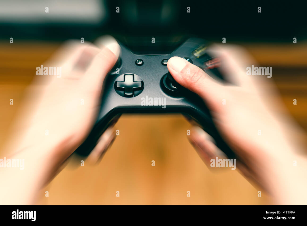 Close-up blur hands with movement pressing and holding a modern game  console joystick Stock Photo - Alamy
