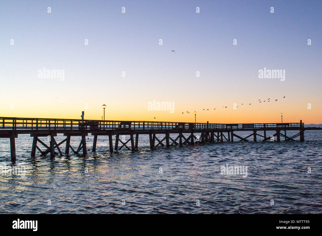 Sunrise over the calm waters in Southport North Carolina - color sky, peaceful tranquility Stock Photo