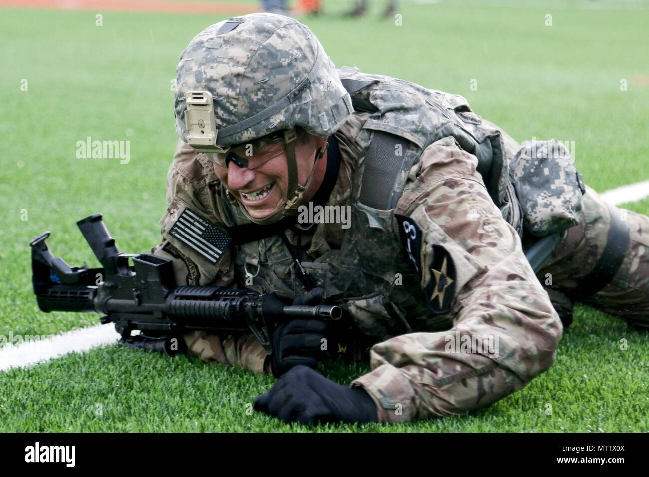 Sgt. 1st Class Terrance Widmer, an Ancona, IL native, assigned to the 2nd Infantry Division/ROK-US Combined Division, performs the high crawl during the physical fitness challenge portion of the Eighth Army 2018 Best Warrior Competition, held at Camp Casey, Republic of Korea, May 17, May 17, 2018. The Eighth Army Best Warrior Competition is being held to recognize and select the most qualified junior enlisted and non-commissioned officer to represent Eighth Army at the U.S. Army Pacific Best Warrior Competition at Schofield Barracks, HI. The competition will also recognize the top performing o Stock Photo