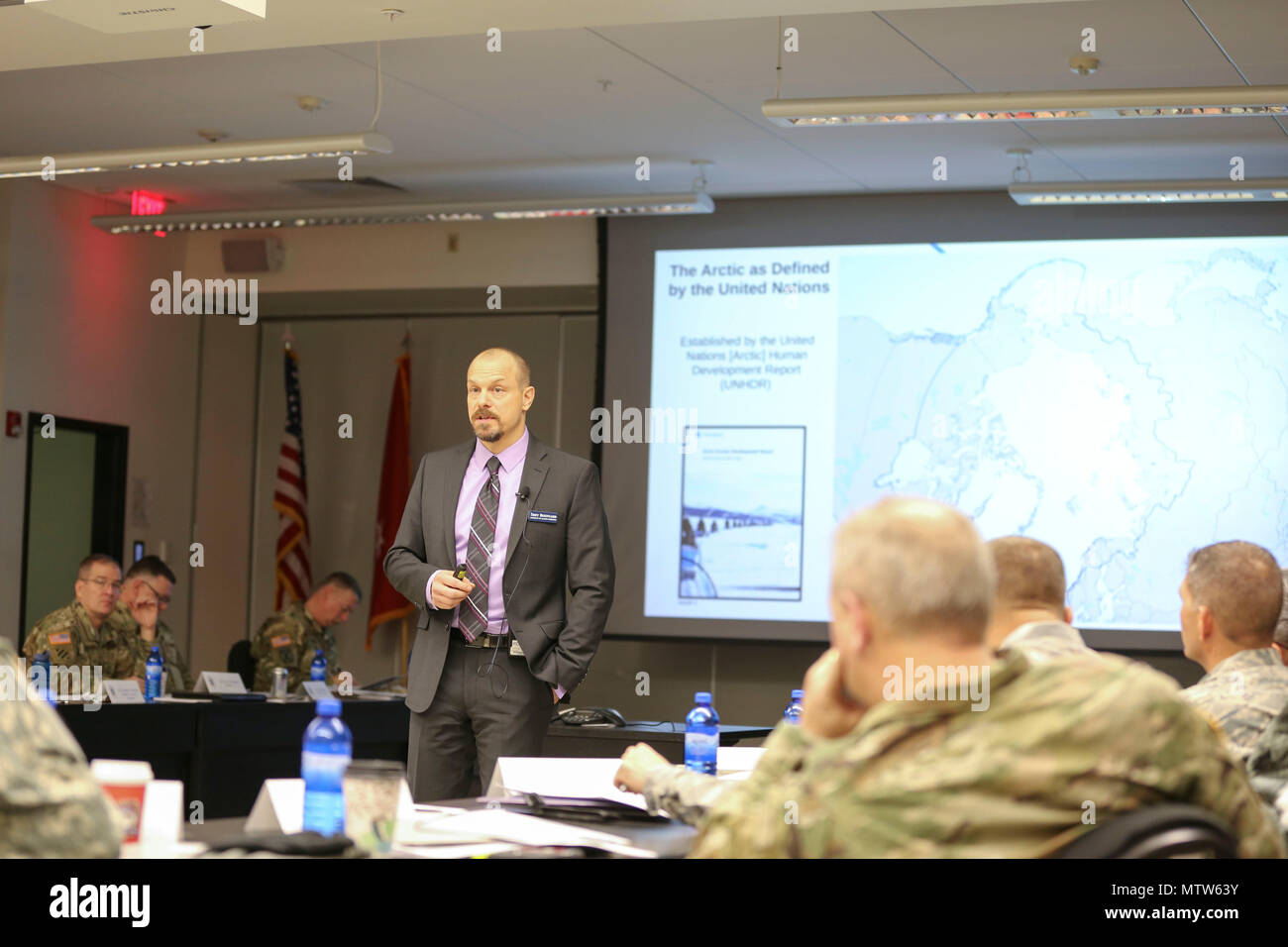 Troy Bouffard, an instructor with the University of Alaska Fairbanks,  presents information on Arctic Domain and Security Orientation during the  2017 National Guard Arctic Summit at the Mission Command Training Center on