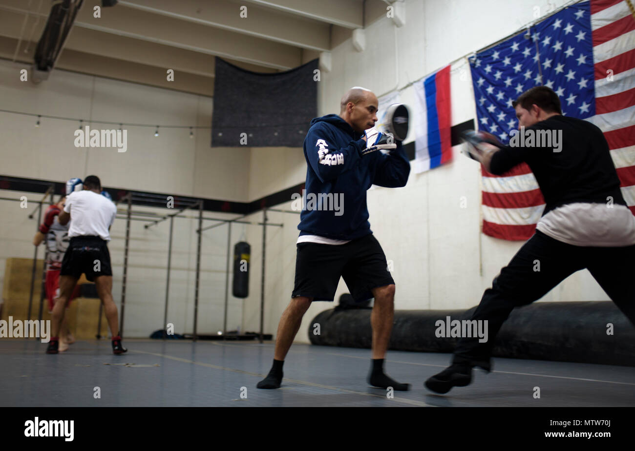 COLORADO SPRINGS, Colo. – Tech. Sgt. Rosey Summerville, 21st Force Support Squadron fitness NCO in charge, trains Isaac Johnson, Colorado Springs professional boxer, and other boxers at the Colorado Springs Judo Center, Colorado Springs, Colo., Jan. 20, 2017. Summerville is a decorated former competitive boxer with two Air Force titles and one Armed Force Golden Glove championship under his belt. (U.S. Air Force photo by Airman 1st Class Dennis Hoffman) Stock Photo