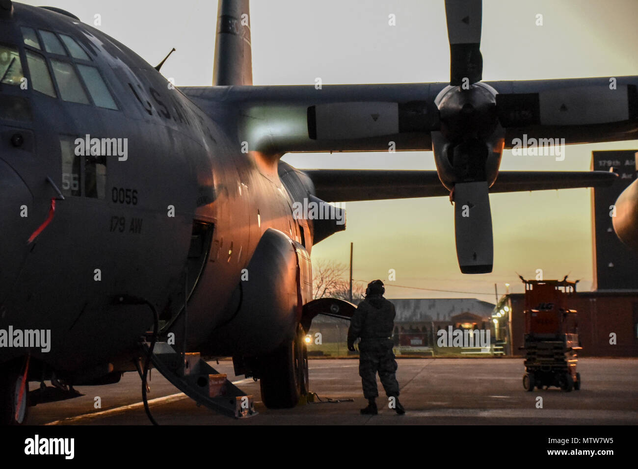 A C-130H Hercules is prepared for daily flight operations on the flightline in the early morning of Jan. 25, 2017, at the 179th Airlift Wing, Mansfield, Ohio. The 179th Airlift Wing is always on a mission to be the first choice to respond to community, state and federal missions with a trusted team of highly qualified Airmen. (U.S. Air National Guard photo by 1st. Lt. Paul Stennett/Released) Stock Photo