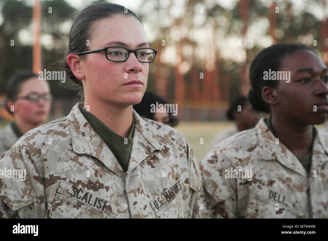 . Marine Corps Rct. Faith Scalisi and Rct. Jasmin Dell with platoon  4004, N. Co., 4th Battalion, Recruit Training Regiment, wait for  instructions during a combat fitness test (CFT) on Marine Corps