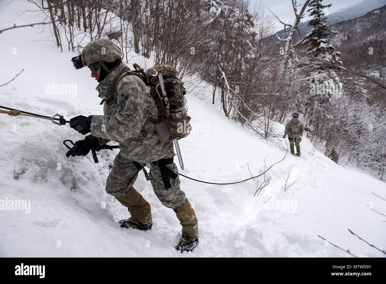 U.S. Army Spc. Saul Hernandez, infantryman, Alpha Company, 3rd Battalion, 172nd Infantry Regiment, 86th Infantry Brigade Combat Team (Mountain), Vermont National Guard participates in a mountain walk at Smugglers' Notch in Jeffersonville, Vt., Jan. 28, 2017. As part of their winter field training exercise, Soldiers enhanced their mountaineering skills in skiing, ice climbing and rappelling. (U.S. Air National Guard photo by Tech. Sgt. Sarah Mattison) Stock Photo