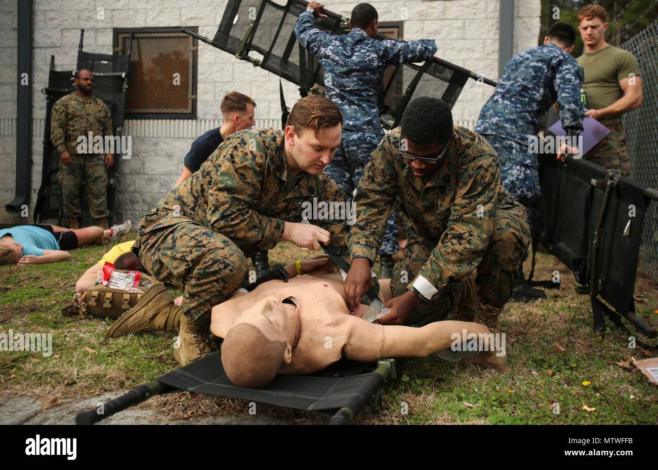 Navy corpsmen secure a notional patient as part of Naval Medical Augmentation Program training at Camp Lejeune, N.C., Jan. 26, 2017. The NMAP training is used to strengthen communication skills in an austere environment and increase combat readiness. The Sailors are with 2nd Medical Battalion. (U.S. Marine Corps photo by Cpl. Ashley Lawson) Stock Photo